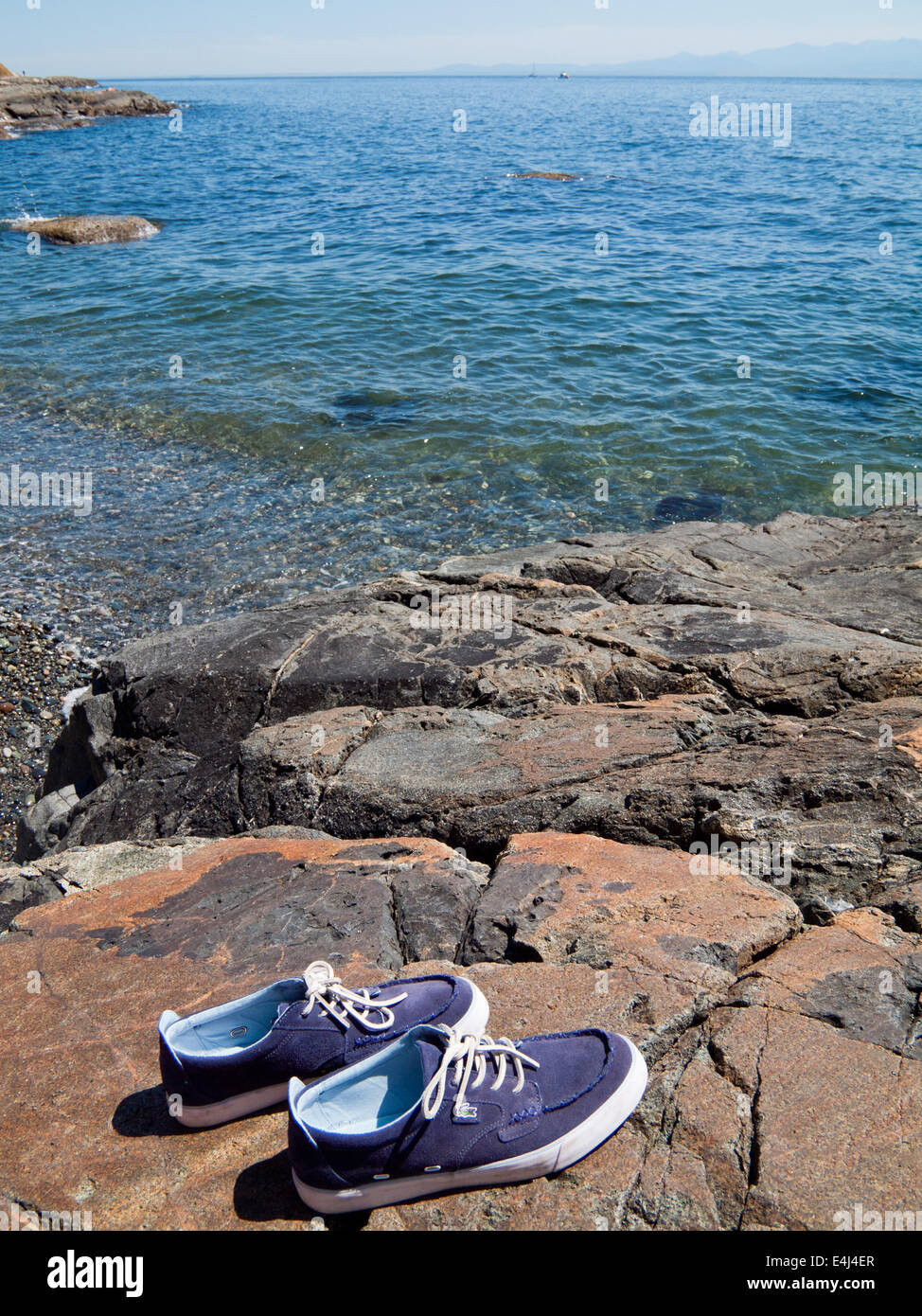 A pair of Lacoste blue suede boat shoes by the ocean.  Victoria, British Columbia, Canada. Stock Photo