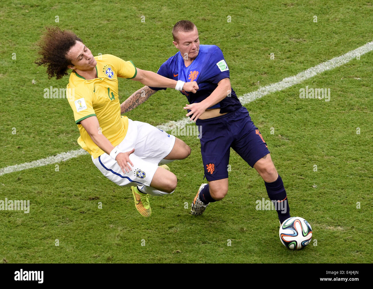 Brasilia, Brazil. 12th July, 2014. Netherlands' Jordy Clasie (R) vies with Brazil's David Luiz during the third place play-off match between Brazil and Netherlands of 2014 FIFA World Cup at the Estadio Nacional Stadium in Brasilia, Brazil, on July 12, 2014. Credit:  Lui Siu Wai/Xinhua/Alamy Live News Stock Photo