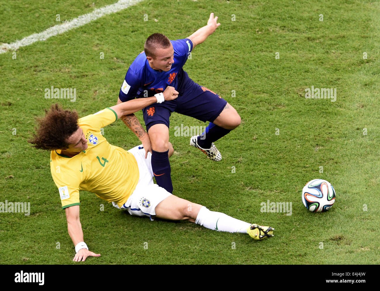 Brasilia, Brazil. 12th July, 2014. Netherlands' Jordy Clasie (R) vies with Brazil's David Luiz during the third place play-off match between Brazil and Netherlands of 2014 FIFA World Cup at the Estadio Nacional Stadium in Brasilia, Brazil, on July 12, 2014. Credit:  Lui Siu Wai/Xinhua/Alamy Live News Stock Photo