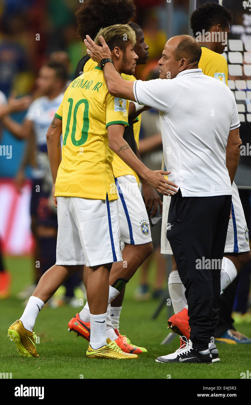 Brasilia, Brazil. 12th July, 2014. Brazil's Neymar (L) leaves the pitch after the third place play-off match between Brazil and Netherlands of 2014 FIFA World Cup at the Estadio Nacional Stadium in Brasilia, Brazil, on July 12, 2014. Netherlands won 3-0 over Brazil and took the third place of the tournament on Saturday. Credit:  Guo Yong/Xinhua/Alamy Live News Stock Photo