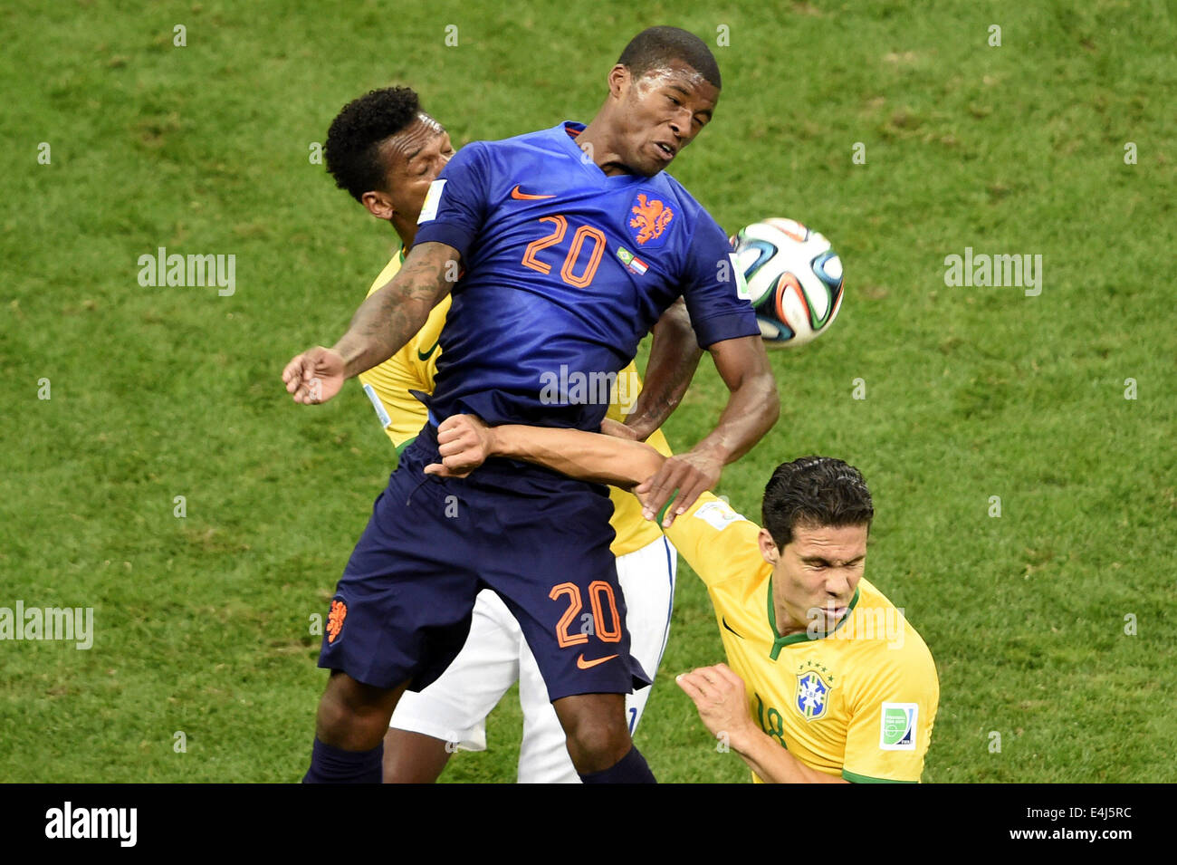 Brasilia, Brazil. 12th July, 2014. Netherlands' Georginio Wijnaldum (C) vies with Brazil's Jo (L) and Hernanes during the third place play-off match between Brazil and Netherlands of 2014 FIFA World Cup at the Estadio Nacional Stadium in Brasilia, Brazil, on July 12, 2014. Netherlands won 3-0 over Brazil and took the third place of the tournament on Saturday. Credit:  Lui Siu Wai/Xinhua/Alamy Live News Stock Photo