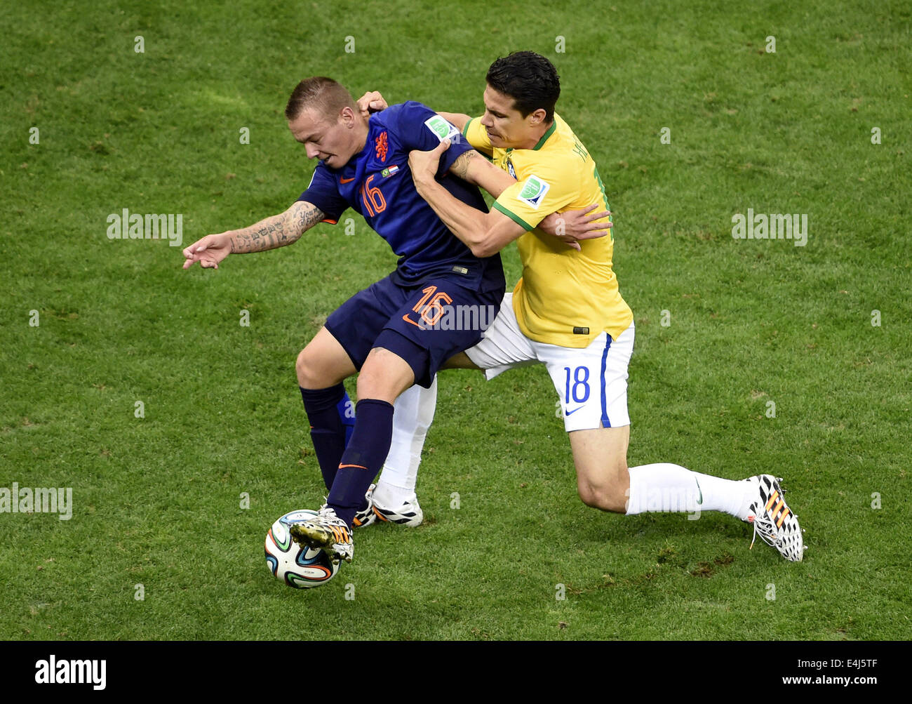 Brasilia, Brazil. 12th July, 2014. Netherlands' Jordy Clasie (L) controls the ball against Brazil's Hernanes during the third place play-off match between Brazil and Netherlands of 2014 FIFA World Cup at the Estadio Nacional Stadium in Brasilia, Brazil, on July 12, 2014. Netherlands won 3-0 over Brazil and took the third place of the tournament on Saturday. Credit:  Lui Siu Wai/Xinhua/Alamy Live News Stock Photo
