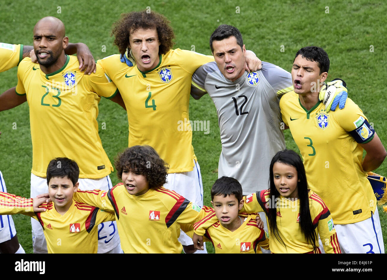 Brasilia, Brazil. 12th July, 2014. Brazil's Maicon, David Luiz, goalkeeper Julio Cesar and Thiago Silva (L to R, back) sing Brazil's national anthem before the third place play-off match between Brazil and Netherlands of 2014 FIFA World Cup at the Estadio Nacional Stadium in Brasilia, Brazil, on July 12, 2014. Credit:  Lui Siu Wai/Xinhua/Alamy Live News Stock Photo