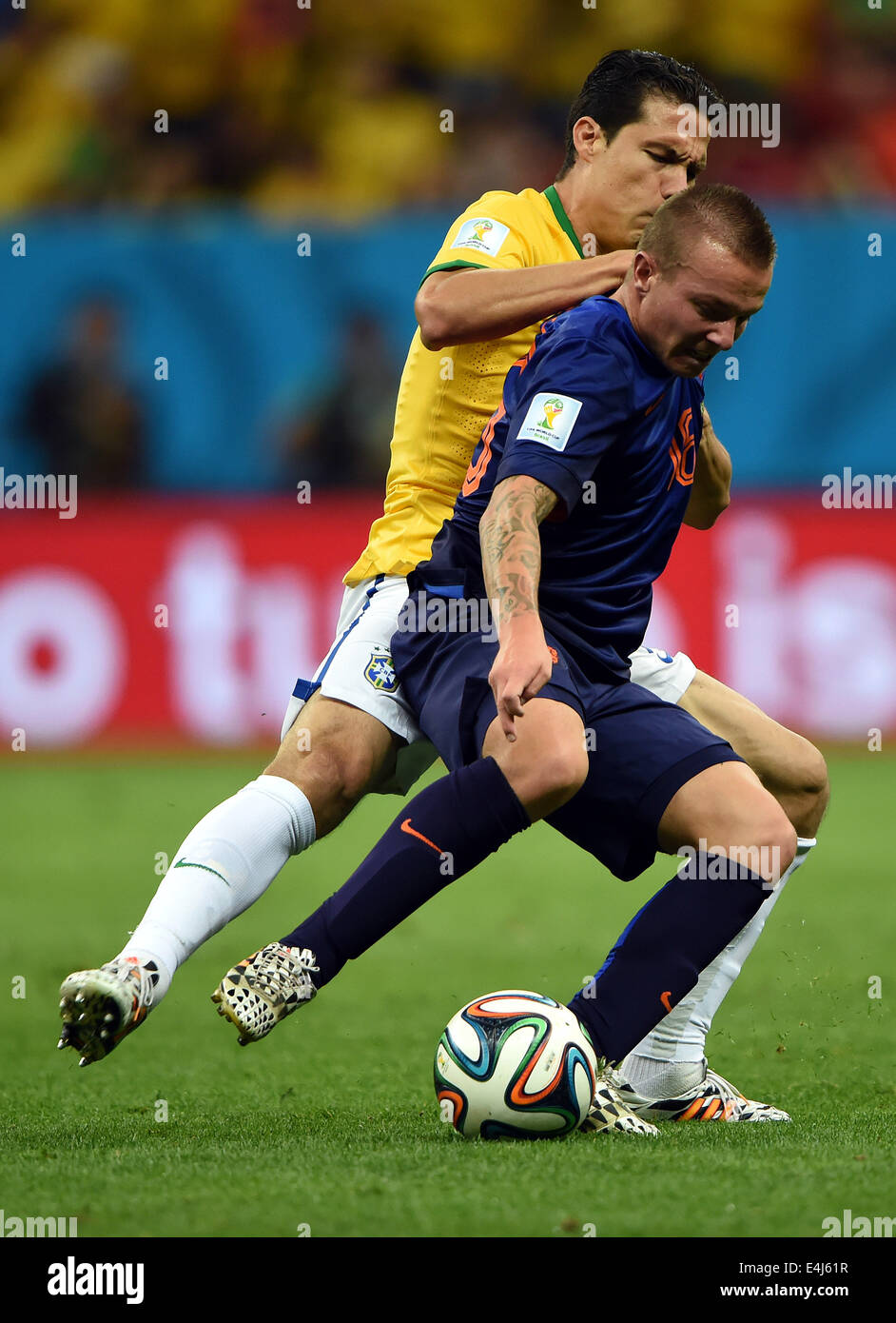 Brasilia, Brazil. 12th July, 2014. Netherlands' Jordy Clasie (R) controls the ball against Brazil's Paulinho during the third place play-off match between Brazil and Netherlands of 2014 FIFA World Cup at the Estadio Nacional Stadium in Brasilia, Brazil, on July 12, 2014. Credit:  Guo Yong/Xinhua/Alamy Live News Stock Photo