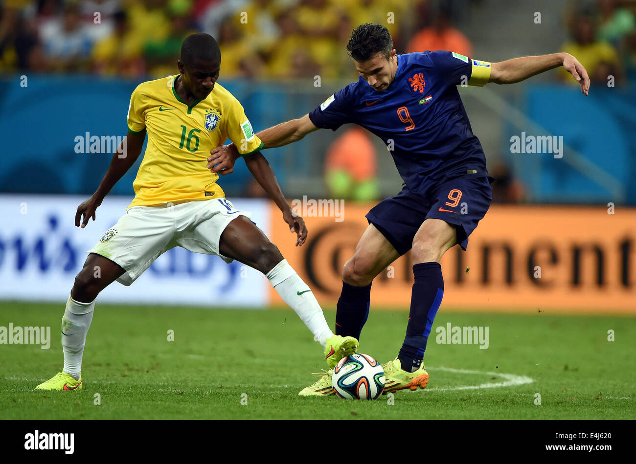 Brasilia, Brazil. 12th July, 2014. Brazil's Ramires (L) vies with Netherlands' Robin van Persie during the third place play-off match between Brazil and Netherlands of 2014 FIFA World Cup at the Estadio Nacional Stadium in Brasilia, Brazil, on July 12, 2014. Credit:  Guo Yong/Xinhua/Alamy Live News Stock Photo