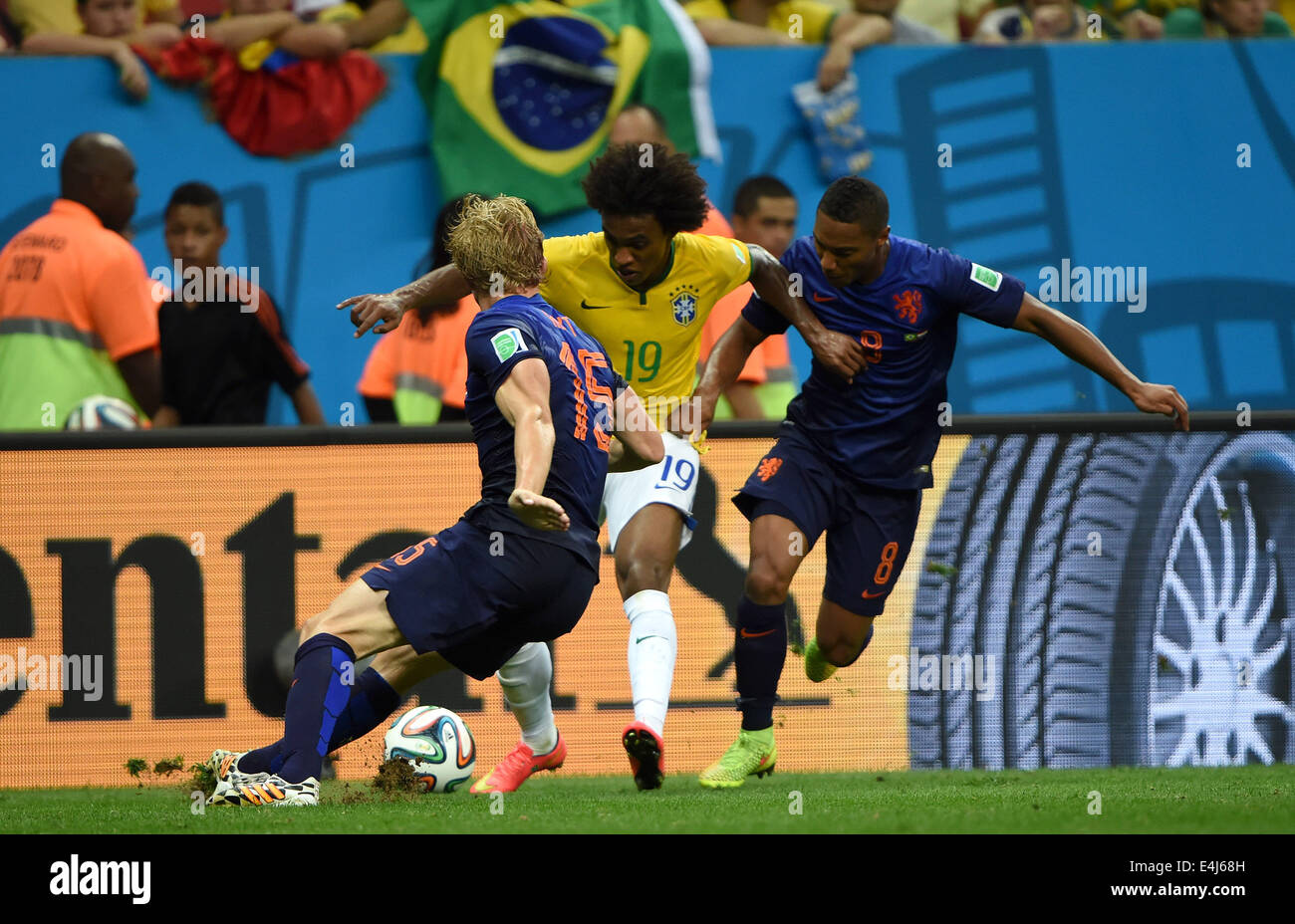 Brasilia, Brazil. 12th July, 2014. Netherlands' Dirk Kuyt (L) and Jonathan De Guzman (R) defend against Brazil's Willian during the third place play-off match between Brazil and Netherlands of 2014 FIFA World Cup at the Estadio Nacional Stadium in Brasilia, Brazil, on July 12, 2014. Netherlands won 3-0 over Brazil and took the third place of the tournament on Saturday. Credit:  Guo Yong/Xinhua/Alamy Live News Stock Photo