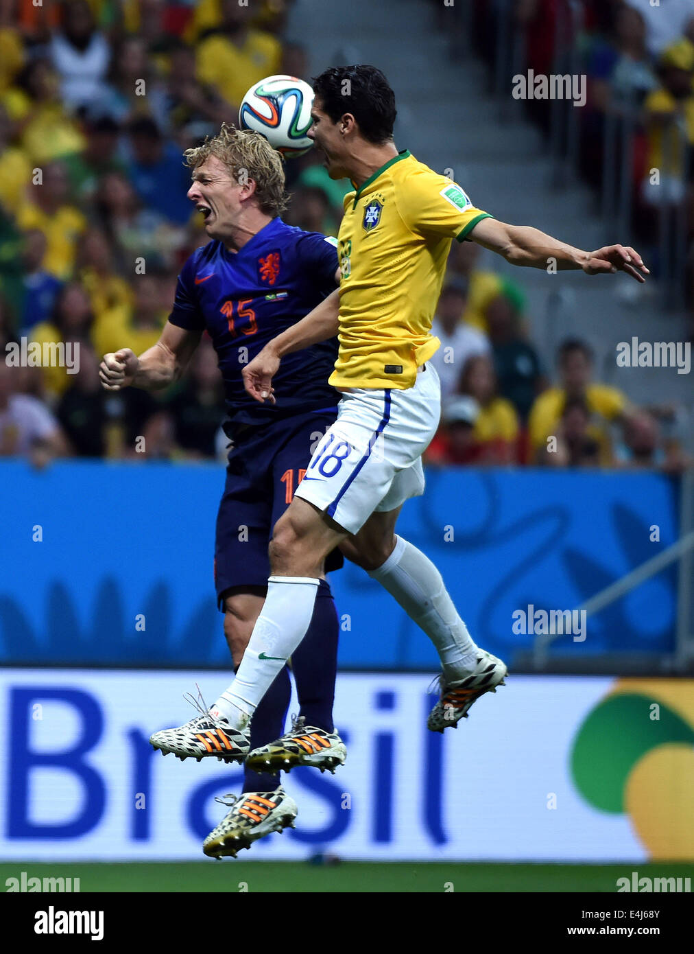 Brasilia, Brazil. 12th July, 2014. Netherlands' Dirk Kuyt (L) vies with Brazil's Hernanes during the third place play-off match between Brazil and Netherlands of 2014 FIFA World Cup at the Estadio Nacional Stadium in Brasilia, Brazil, on July 12, 2014. Netherlands won 3-0 over Brazil and took the third place of the tournament on Saturday. Credit:  Guo Yong/Xinhua/Alamy Live News Stock Photo