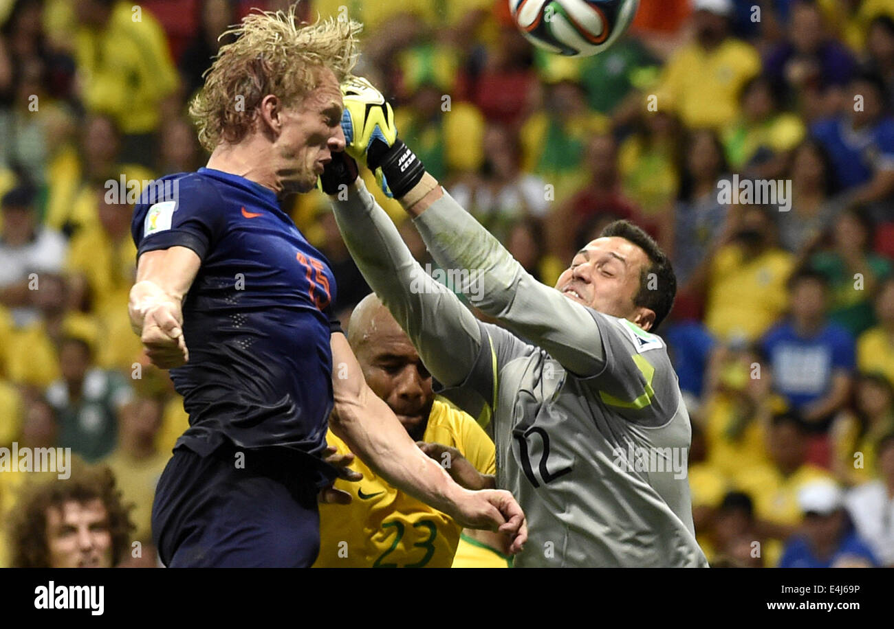 Brasilia, Brazil. 12th July, 2014. Netherlands' Dirk Kuyt (L) vies with Brazil's goalkeeper Julio Cesar (R) during the third place play-off match between Brazil and Netherlands of 2014 FIFA World Cup at the Estadio Nacional Stadium in Brasilia, Brazil, on July 12, 2014. Netherlands won 3-0 over Brazil and took the third place of the tournament on Saturday. Credit:  Yang Lei/Xinhua/Alamy Live News Stock Photo