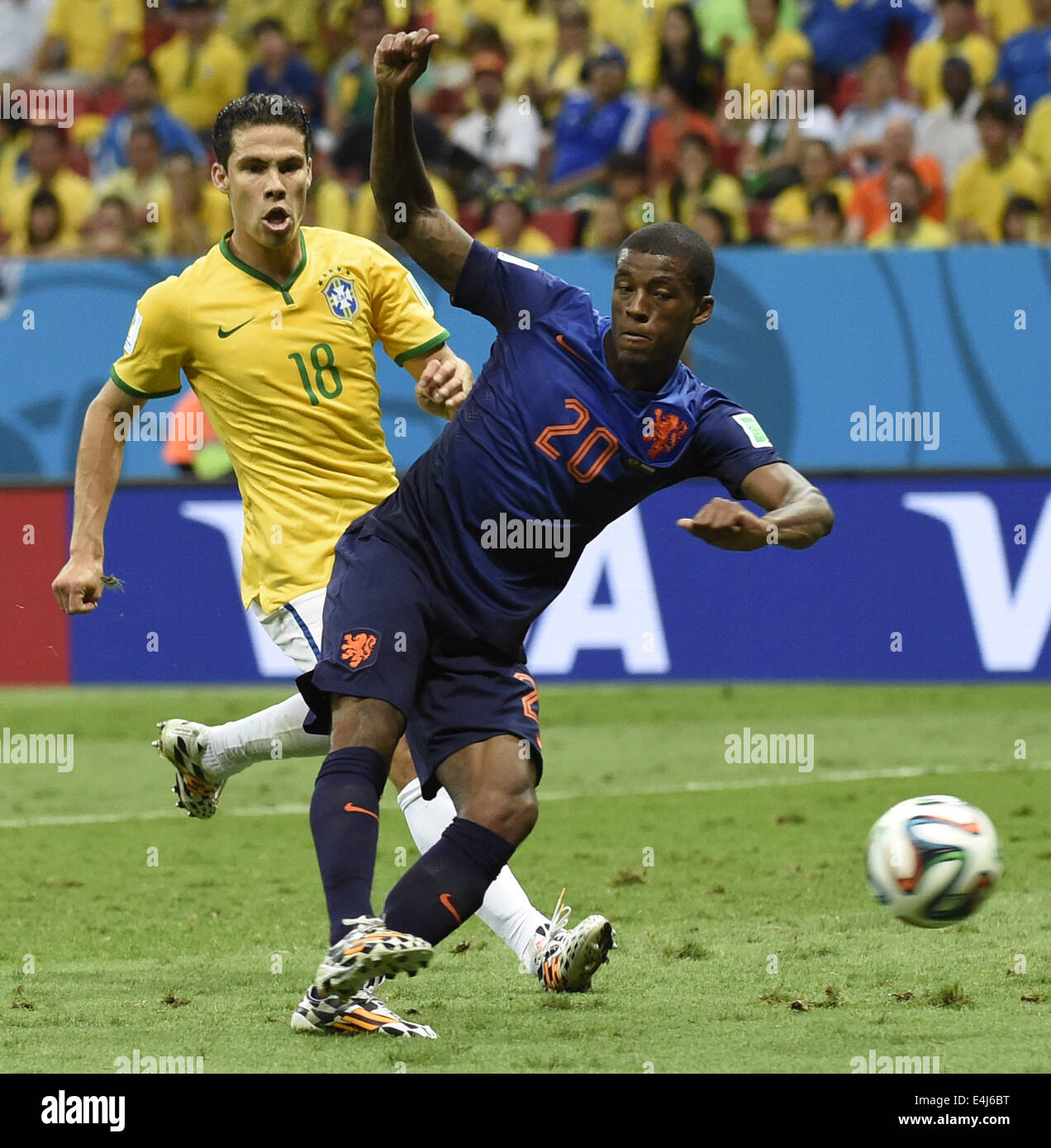 Brasilia, Brazil. 12th July, 2014. Netherlands' Georginio Wijnaldum vies with Brazil's Hernanes during the third place play-off match between Brazil and Netherlands of 2014 FIFA World Cup at the Estadio Nacional Stadium in Brasilia, Brazil, on July 12, 2014. Netherlands won 3-0 over Brazil and took the third place of the tournament on Saturday. Credit:  Yang Lei/Xinhua/Alamy Live News Stock Photo