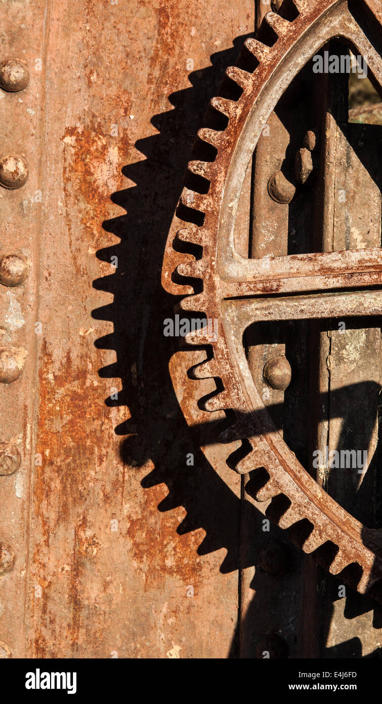 A large iron gear wheel on an old crane photographed on a sunny day Stock Photo