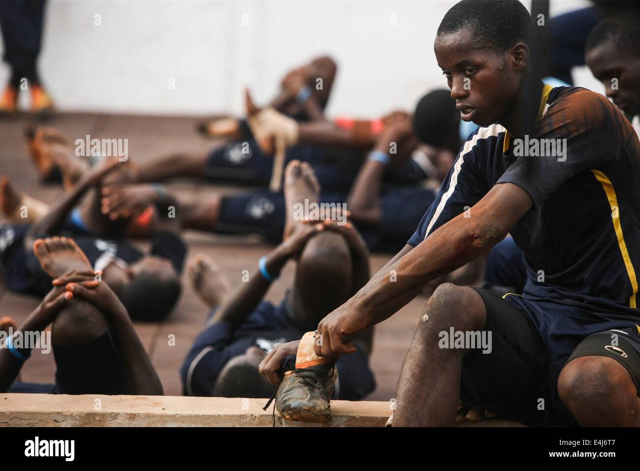 Dakar, Senegal. 9th July, 2014. Football players of Sports 4 Charity relax after a training session in Dakar, capital of Senegal, July 9, 2014. Sports 4 Charity was founded by Senegalese fooball player Salif Diao to help poor youths of Africa have a chance to get an access to education and sports. The young players are provided with funds and facilities and have opportunities to serve European or US footall teams once they finish their trainings. © Li Jing/Xinhua/Alamy Live News Stock Photo