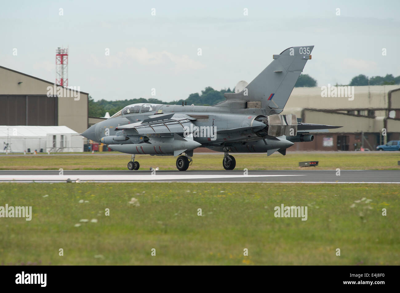 RAF Fairford, Gloucestershire UK. 11th July 2014. Fast jets on display at the first day of RIAT. RAF Panavia Tornado GR4 035 landing with reverse thrusters deployed. Credit:  Malcolm Park editorial/Alamy Live News Stock Photo