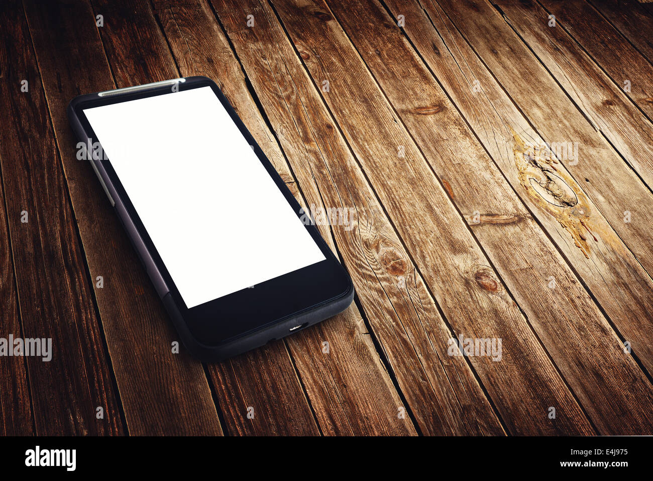 Generic mobile smart phone with blank white screen on wooden table ...