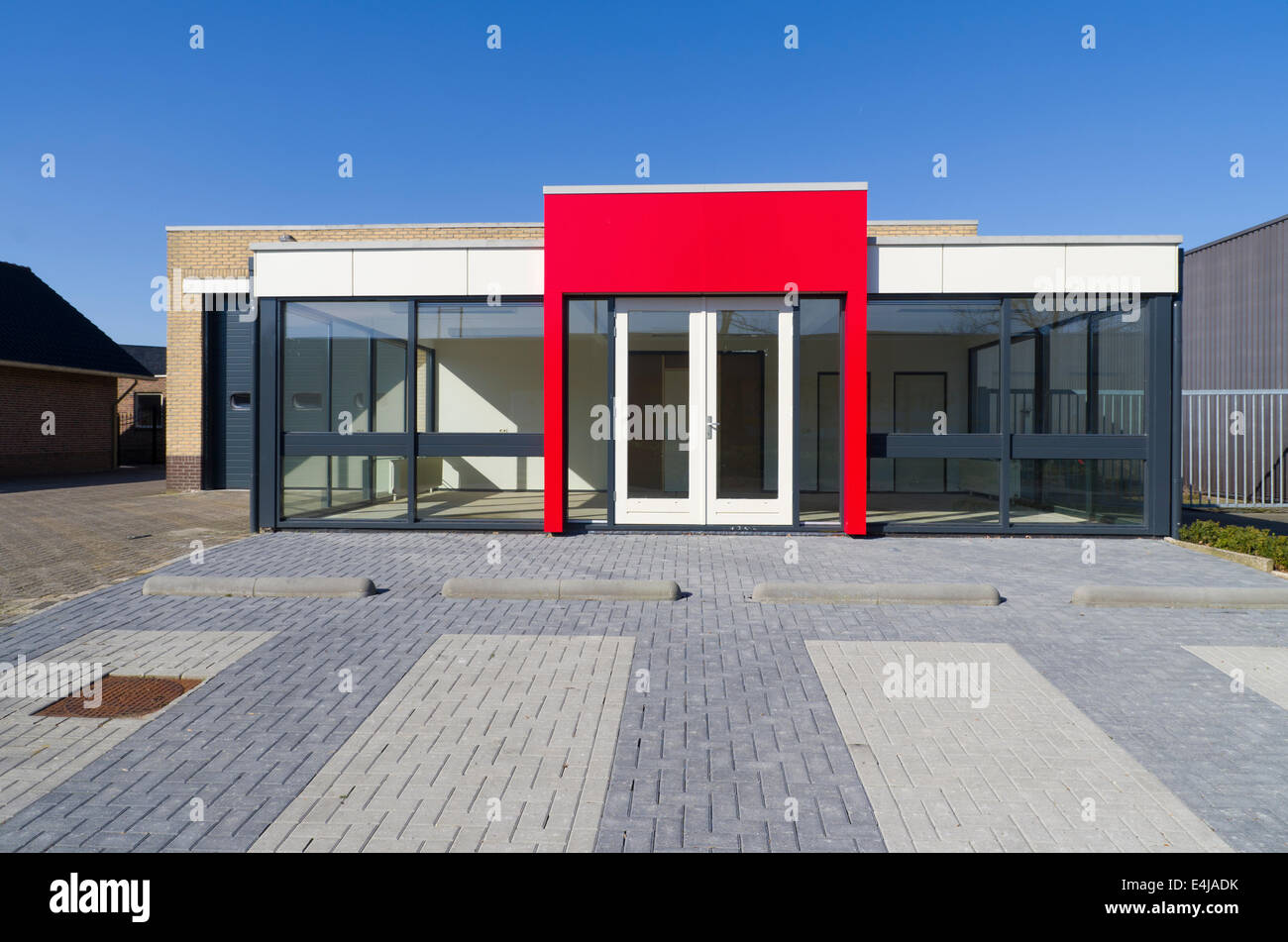 empty small office building with red entrance Stock Photo
