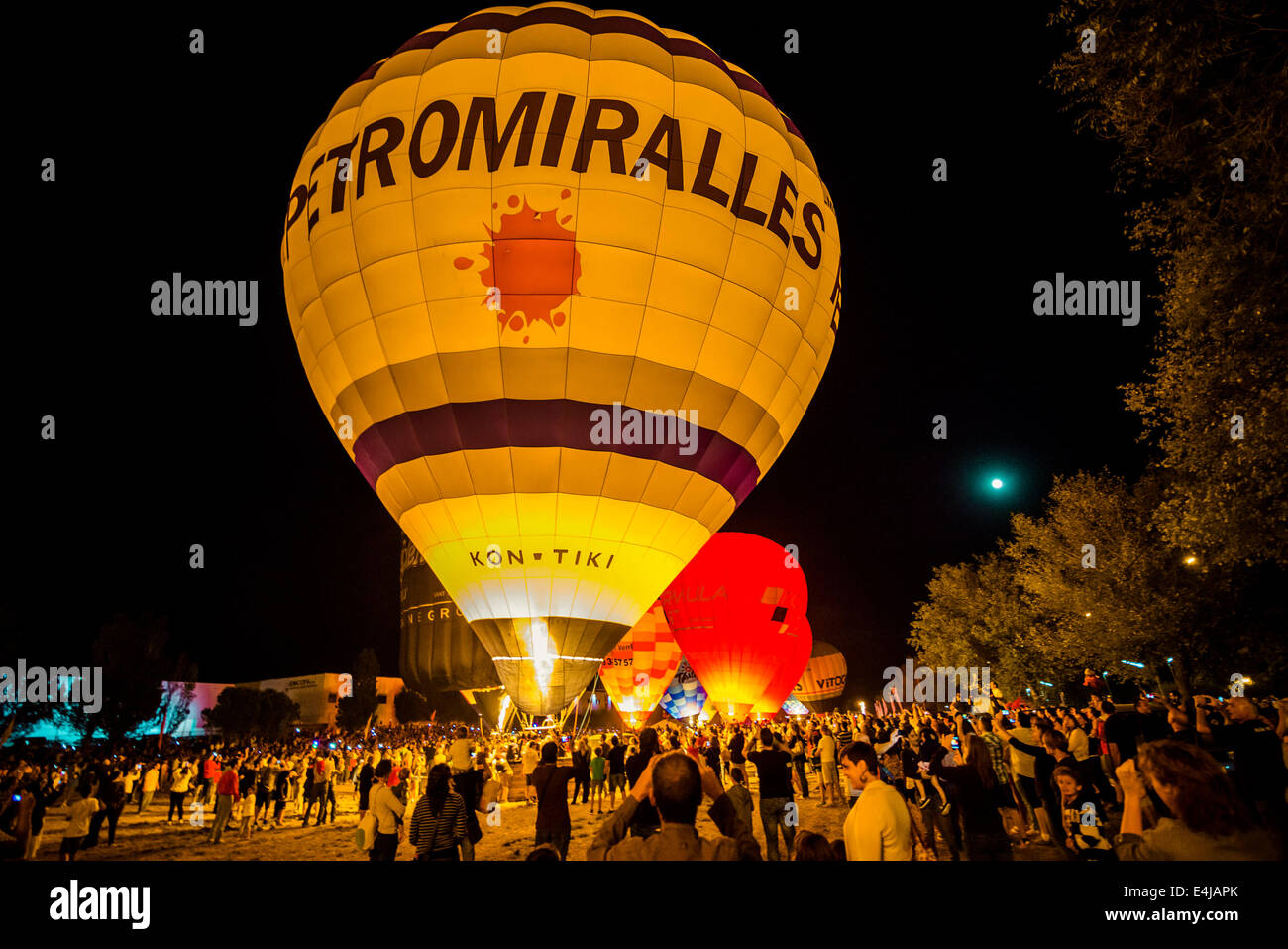 Barcelona, Catalonia, Spain. 12th July, 2014. Thousands enjoy the glowing Hot air balloons in the night of Igualada as they are lit up during the Glow Night event at the European Balloon Festival. Credit:  Matthias Oesterle/ZUMA Wire/ZUMAPRESS.com/Alamy Live News Stock Photo