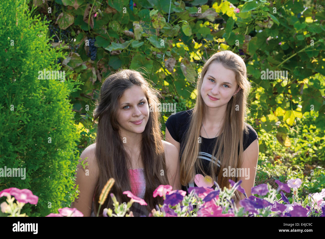 Teen girls on a background of flowers Stock Photo