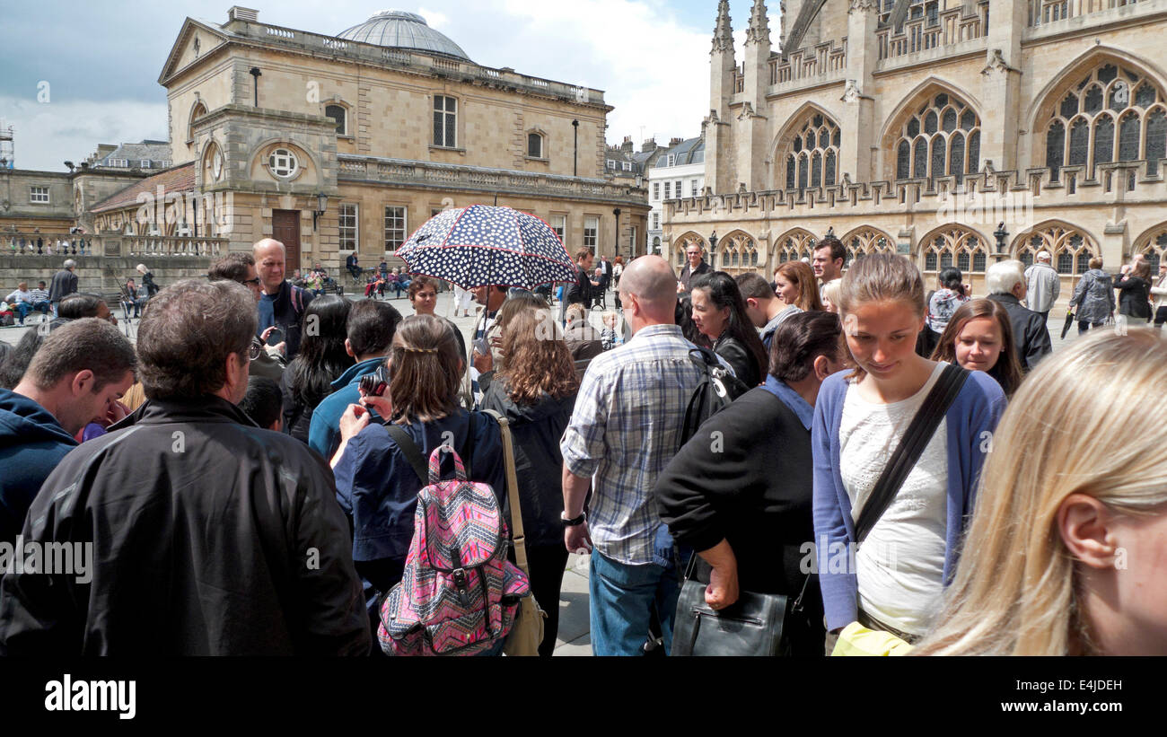 Tourists watching performers in courtyard outside at Bath Abbey Somerset, England UK  KATHY DEWITT Stock Photo