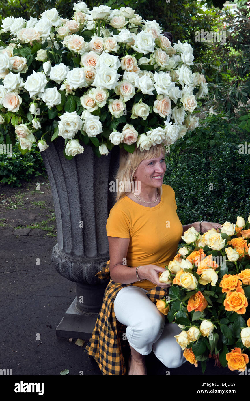Woman posing and bunch of roses at LU Botanical Garden Riga Latvia Stock Photo