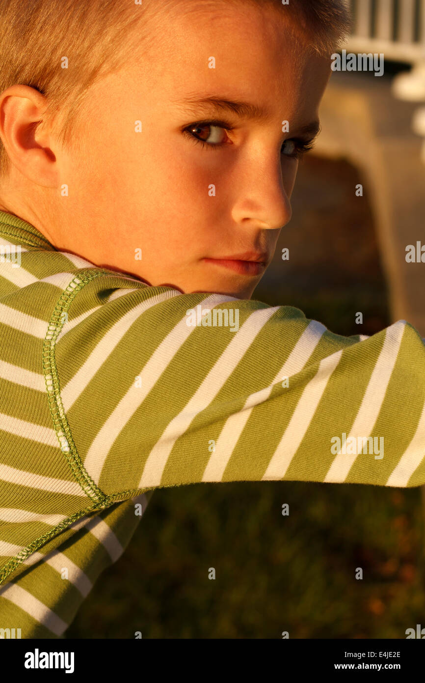 Young boy outdoors looking at camera Stock Photo - Alamy