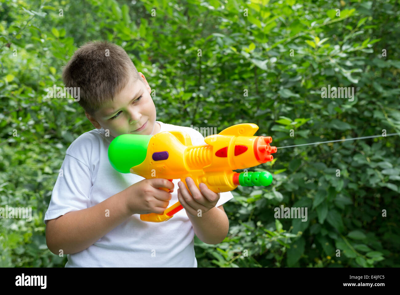 Boy with water pistol Stock Photo Alamy