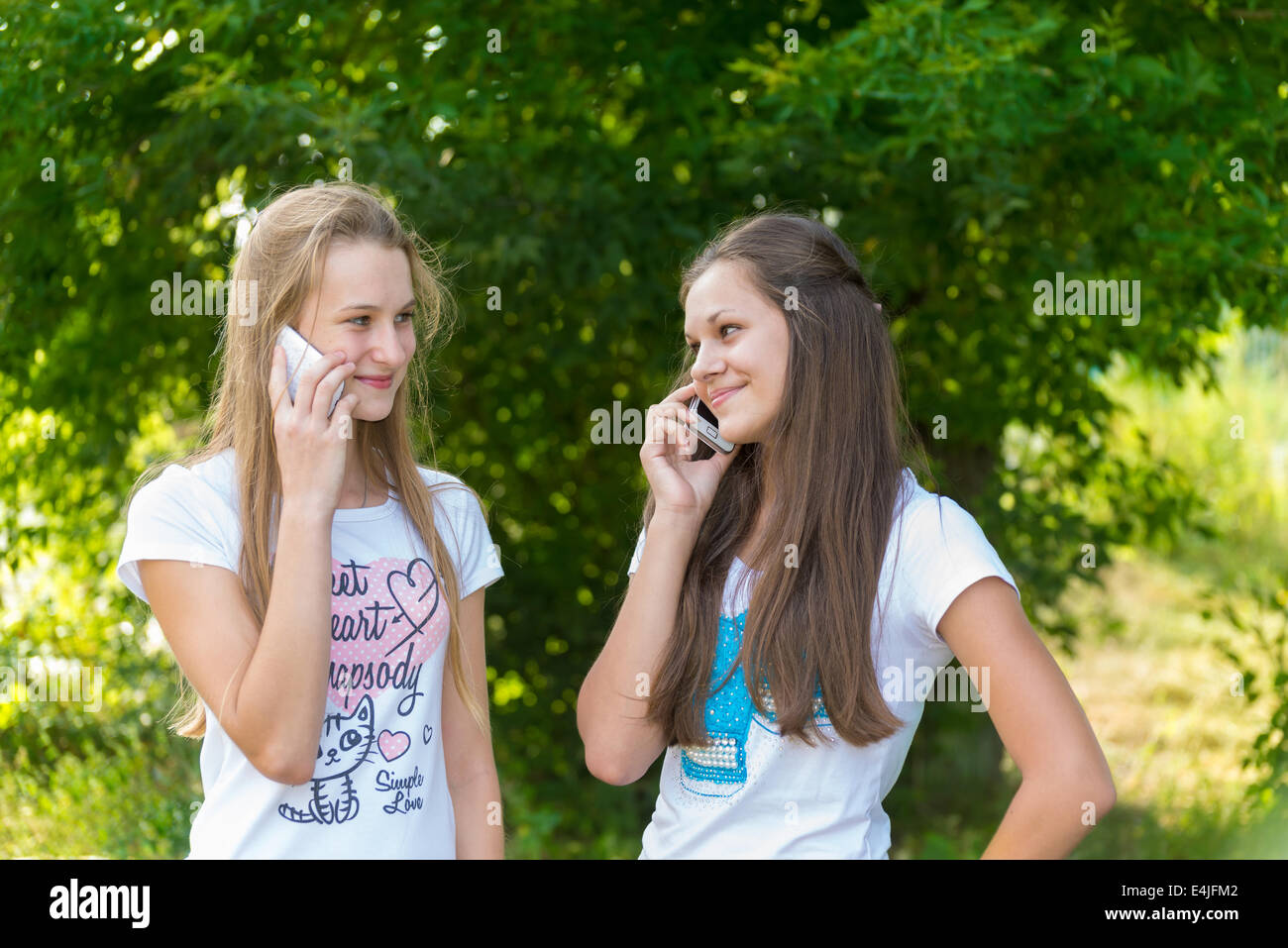 Teen girls talking on cell phone Stock Photo