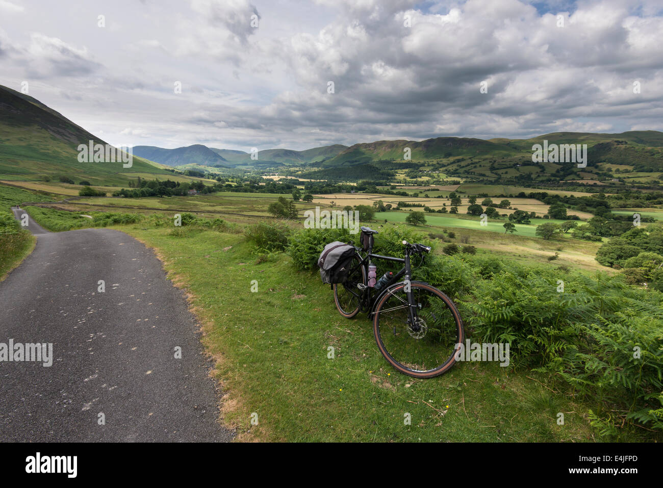 A bicycle, on the side of the 'gated road' of Whinlatter Pass, in front of the Lorton Vale in the English Lake District Stock Photo