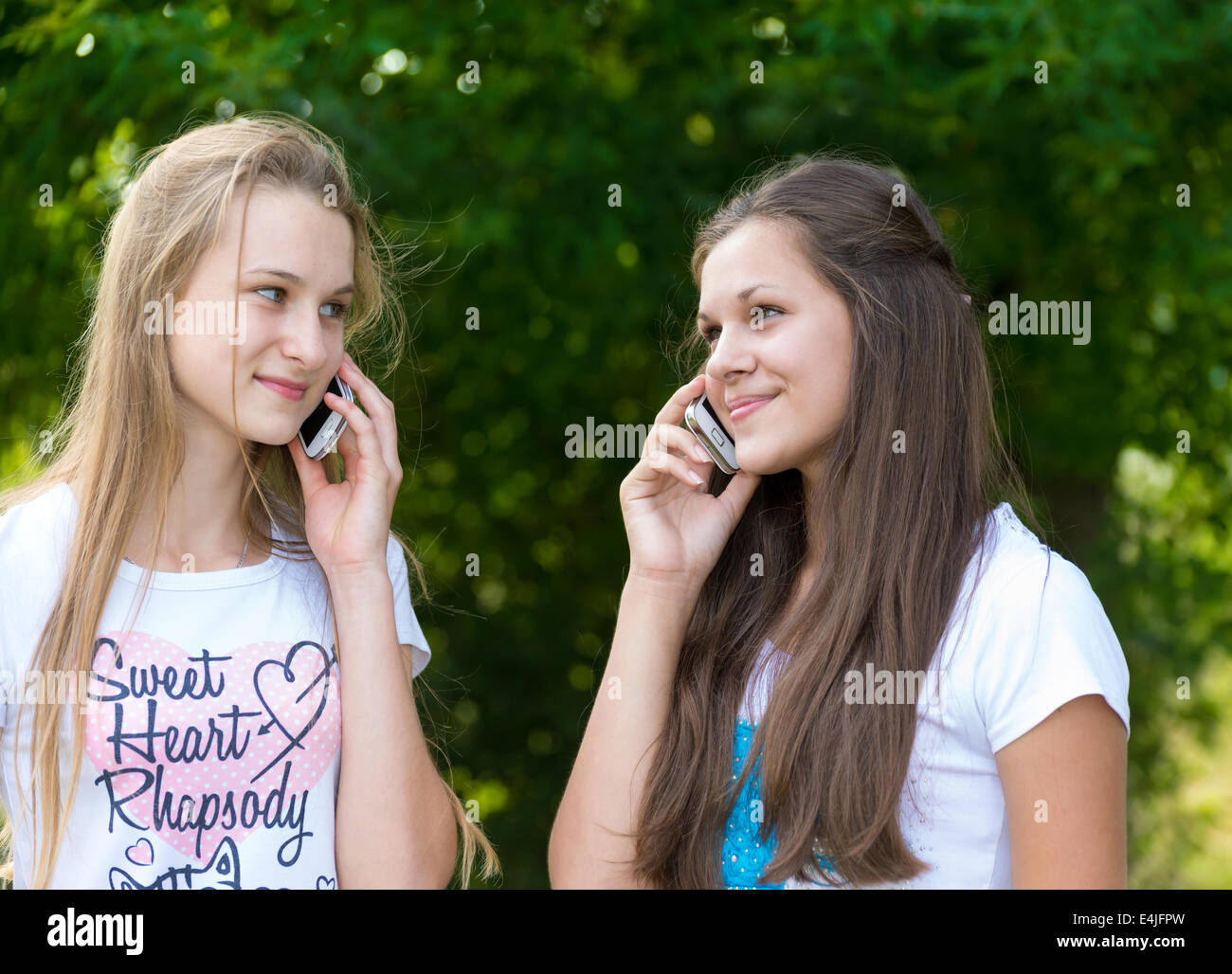 Teen girls talking on cell phone Stock Photo