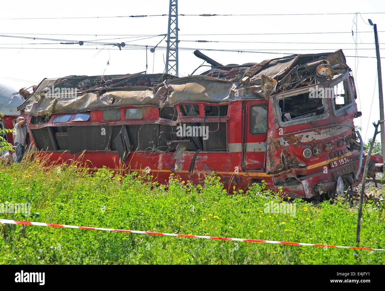 Kalojanovec, BGR. 13th July, 2014. Bulgarian police officers and rescue workers attend near train crash near the village of Kalojanovec east of the Bulgarian capital Sofia, Sunday, July, 13, 2014. One man died after a train traveling from Sofia to Varna derailed near the central Bulgarian village of Kalojanovec on Saturday, 15:17 EEST (13:17 GMT). The victim was the train's driver. Fifteen pasengers were left injured, two of them in a critical condition, authorities say.Photo by: /Impact Press Group/NurPhoto Credit:  Petar Petrov/NurPhoto/ZUMA Wire/Alamy Live News Stock Photo