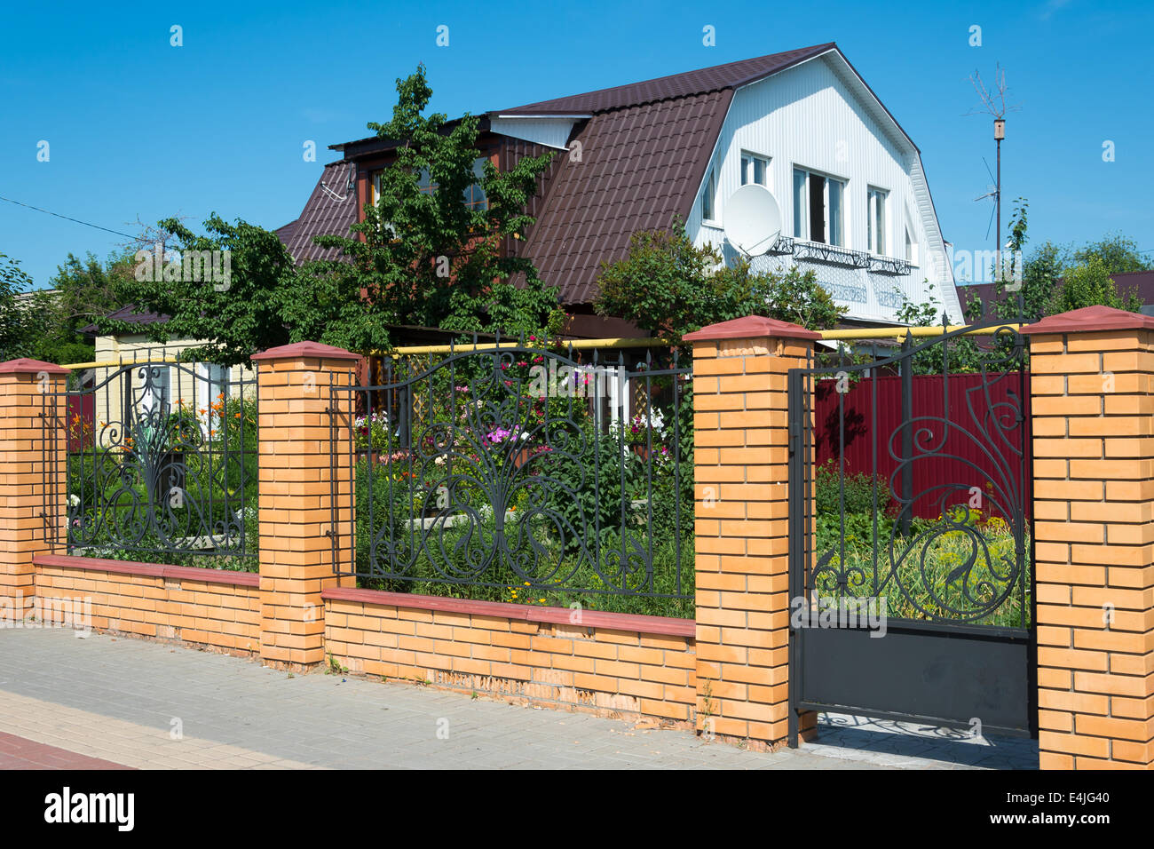 Wonderful family house a brick fence Stock Photo