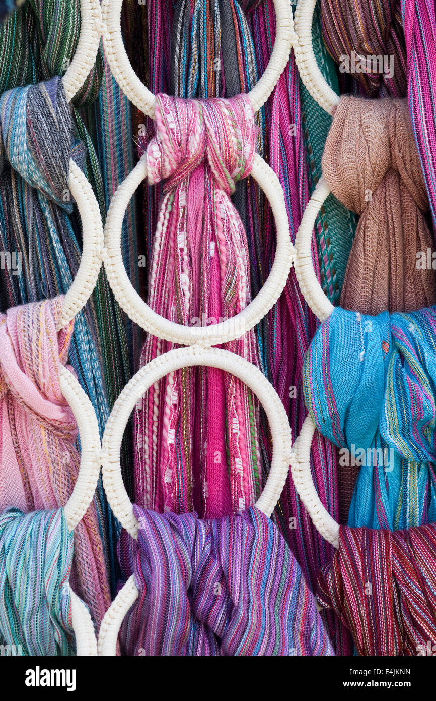 Colorful ethnic decorated shawls and scarfs on a ringed hanger Stock Photo