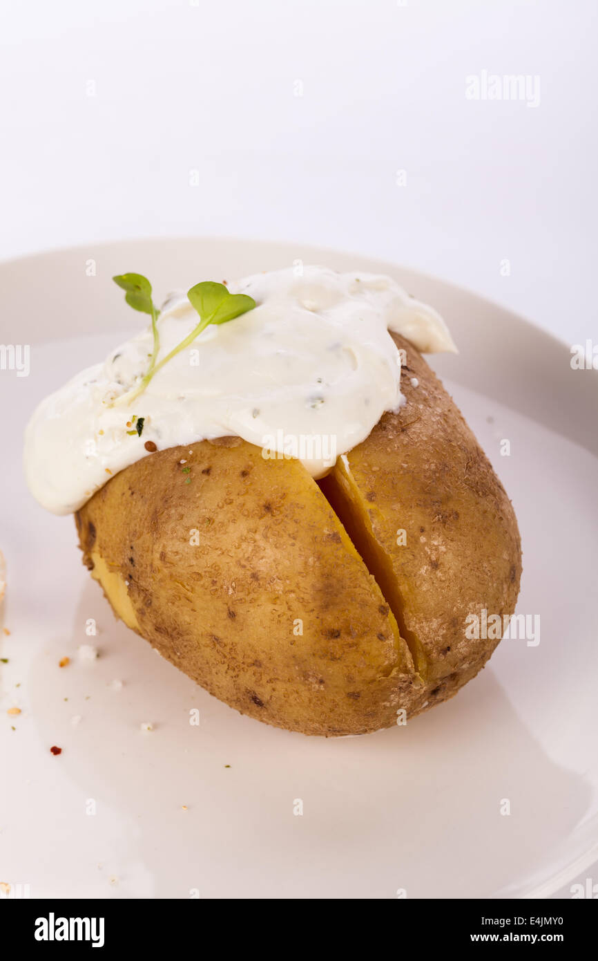 Overhead view of a healthy oven baked jacket potato with sour cream