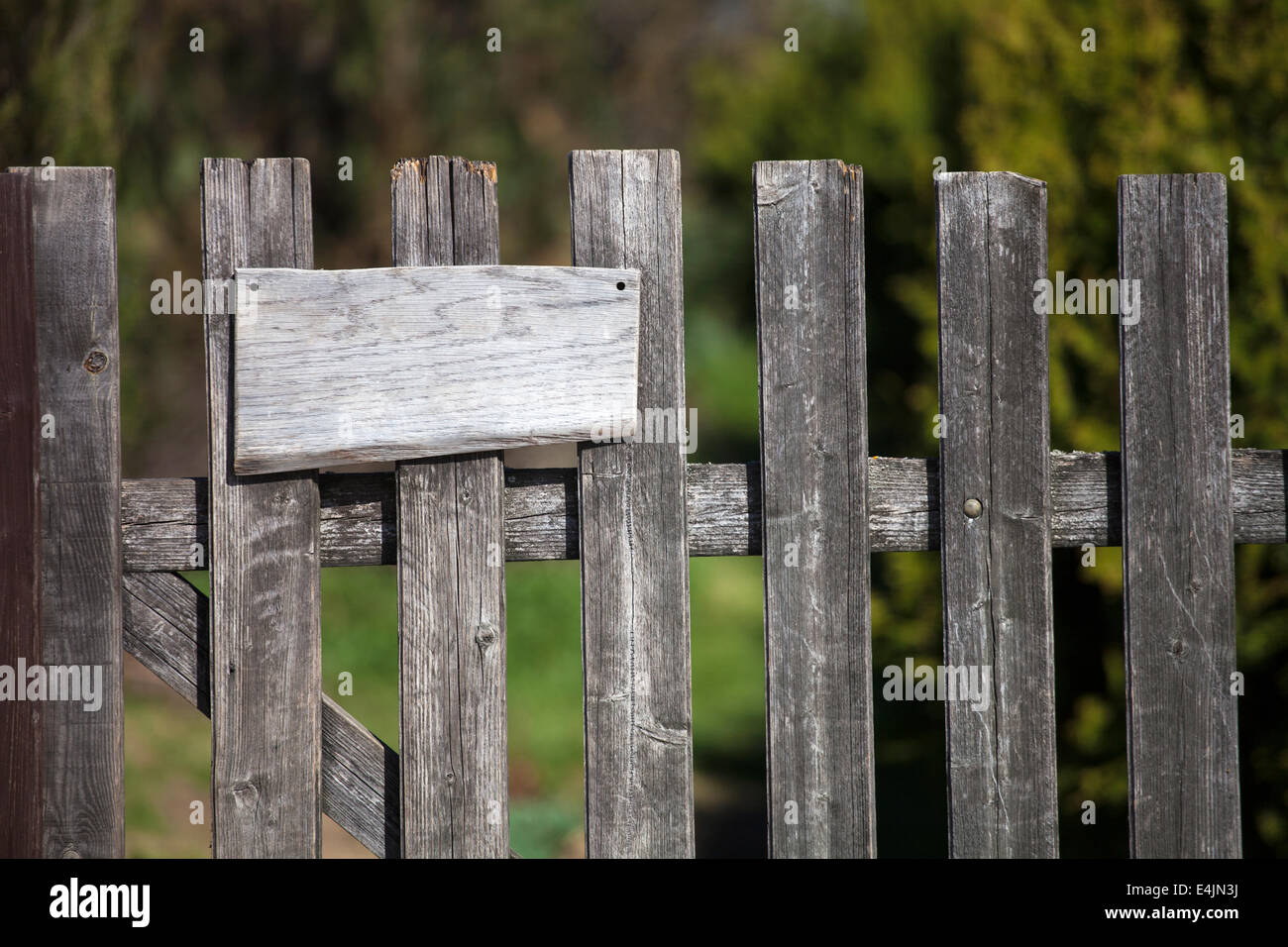 Old wooden fence with empty sign board Stock Photo