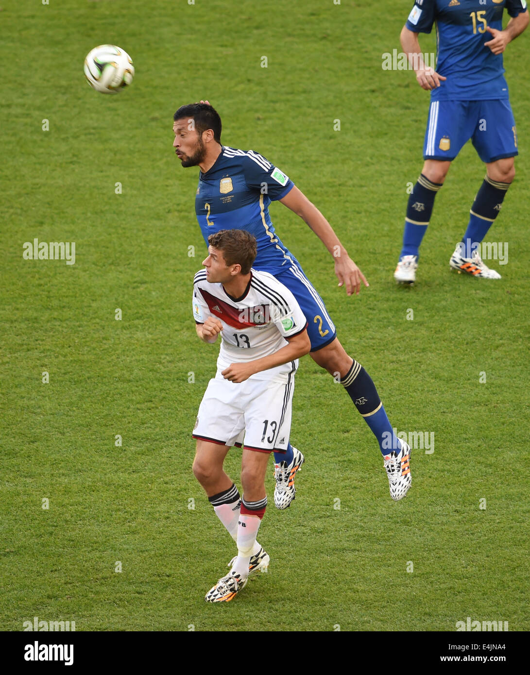 Rio De Janeiro, Brazil. 13th July, 2014. Germany's Thomas Muller vies with Argentina's Ezequiel Garay during the final match between Germany and Argentina of 2014 FIFA World Cup at the Estadio do Maracana Stadium in Rio de Janeiro, Brazil, on July 13, 2014. Credit:  Li Ga/Xinhua/Alamy Live News Stock Photo