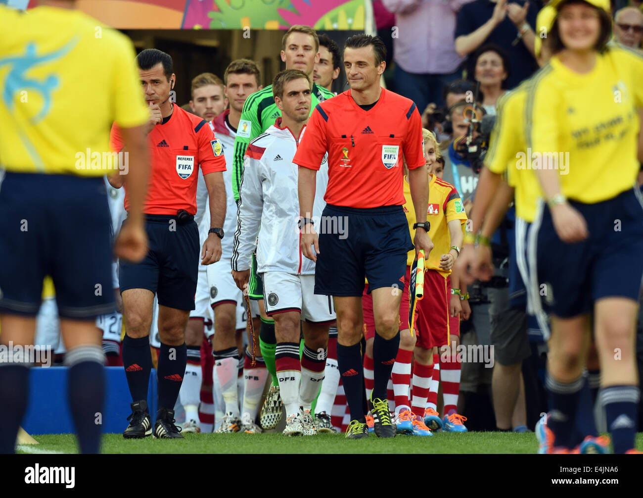 Rio de Janeiro, Brazil. 13th July, 2014. Philipp Lahm (C) and goalkeeper Manuel Neuer (C back) of Germany arrive on the pitch during the FIFA World Cup 2014 final soccer match between Germany and Argentina at the Estadio do Maracana in Rio de Janeiro, Brazil, 13 July 2014. Photo: Marcus Brandt/dpa/Alamy Live News Stock Photo
