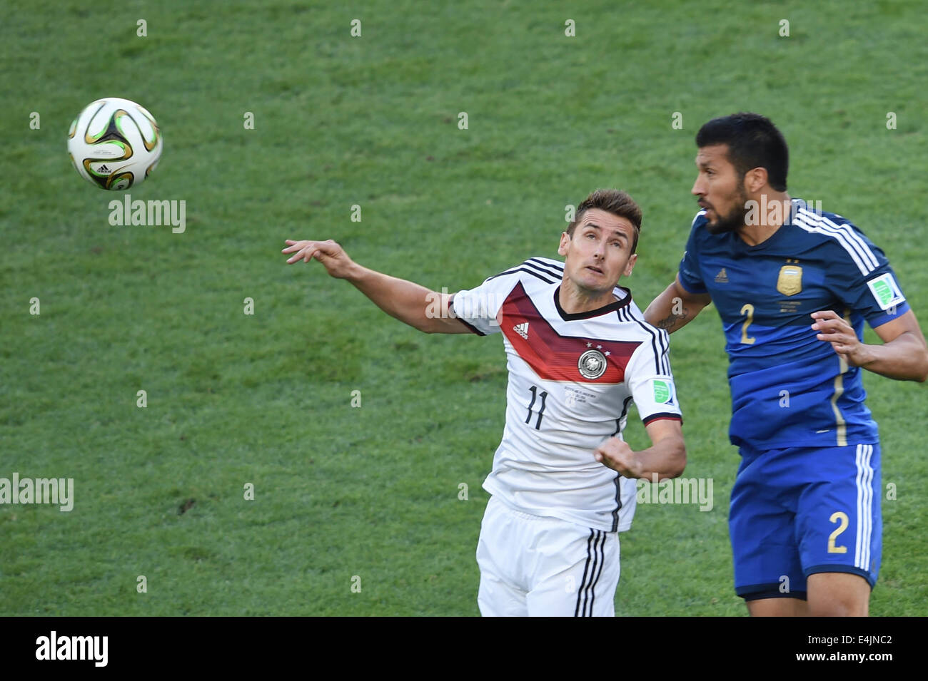 Rio De Janeiro, Brazil. 13th July, 2014. Germany's Miroslav Klose (L) vies with Argentina's Ezequiel Garay during the final match between Germany and Argentina of 2014 FIFA World Cup at the Estadio do Maracana Stadium in Rio de Janeiro, Brazil, on July 13, 2014. Credit:  Li Ga/Xinhua/Alamy Live News Stock Photo