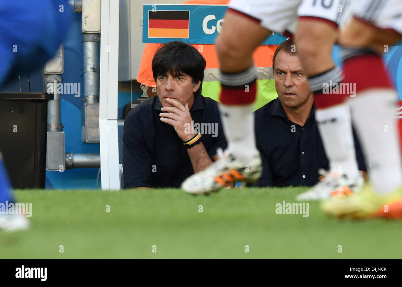Rio de Janeiro, Brazil. 13th July, 2014. Head coach Joachim Loew (L) and assistant coach Hansi Flick of Germany sit on the bench during the FIFA World Cup 2014 final soccer match between Germany and Argentina at the Estadio do Maracana in Rio de Janeiro, Brazil, 13 July 2014. Photo: Marcus Brandt/dpa/Alamy Live News Stock Photo