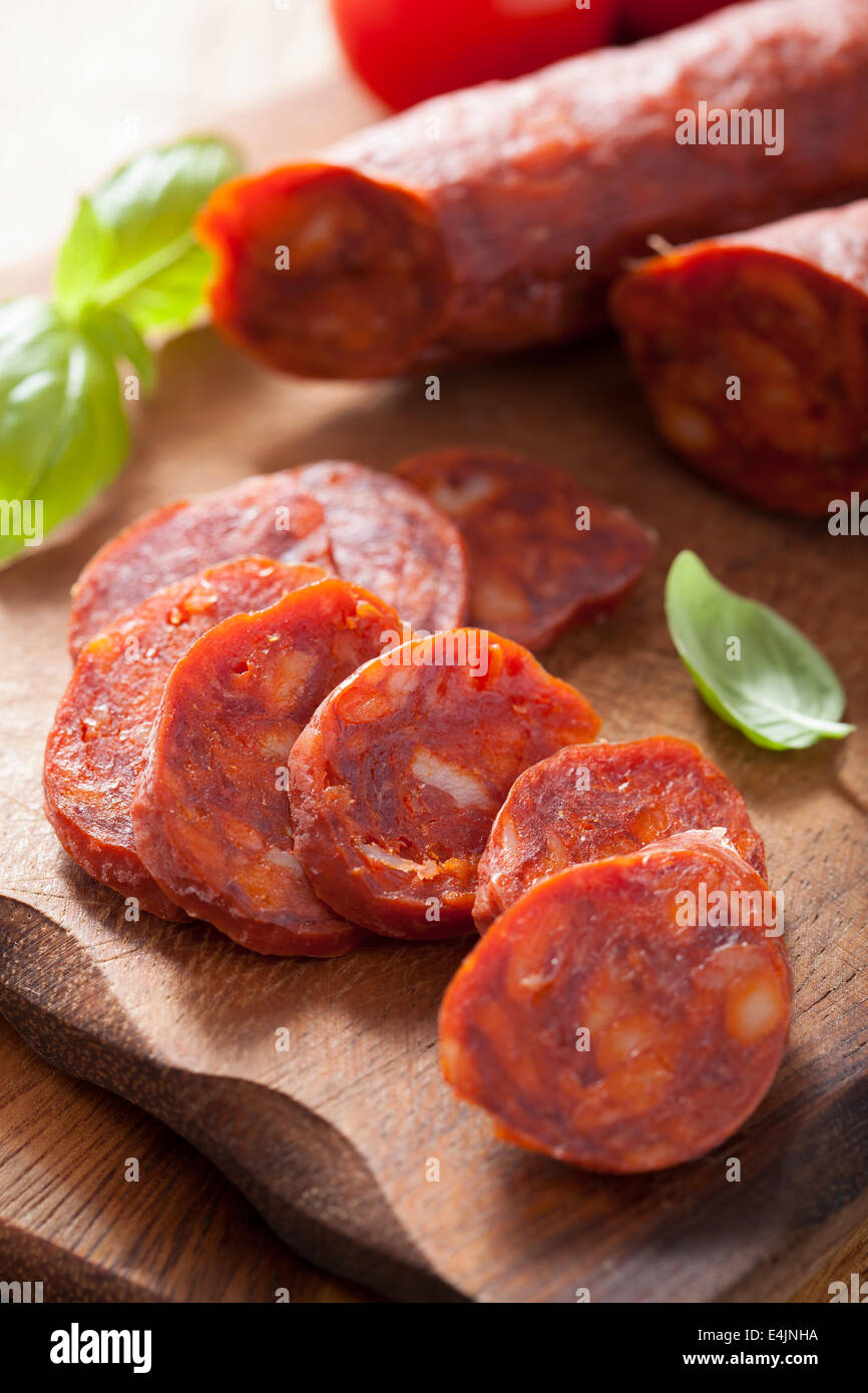 spanish chorizo sausage with basil on chopping board Stock Photo - Alamy