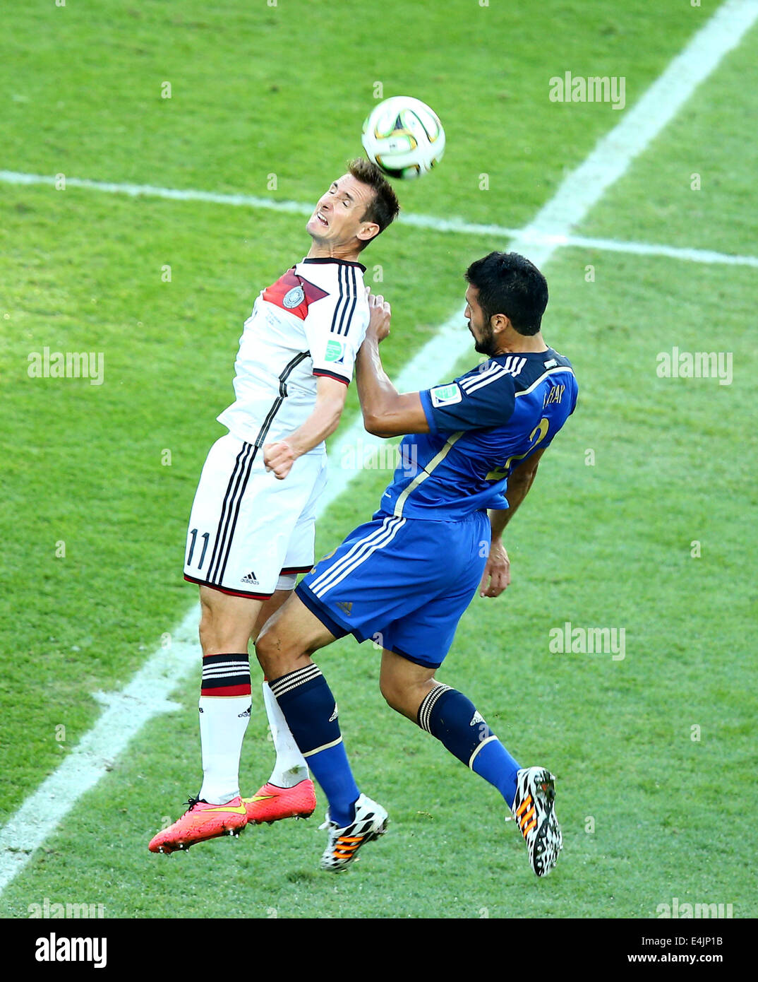 Rio De Janeiro, Brazil. 13th July, 2014. Germany's Miroslav Klose competes for a header with Argentina's Ezequiel Garay during the final match between Germany and Argentina of 2014 FIFA World Cup at the Estadio do Maracana Stadium in Rio de Janeiro, Brazil, on July 13, 2014. Credit:  Chen Jianli/Xinhua/Alamy Live News Stock Photo