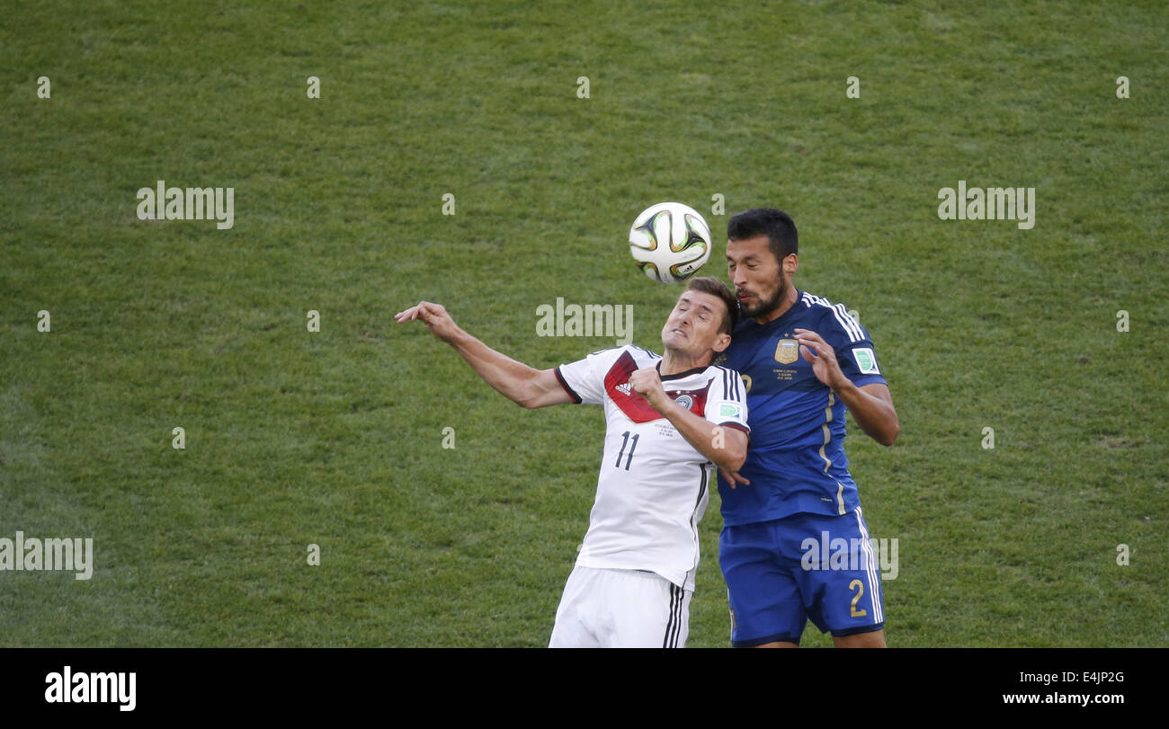 Rio De Janeiro, Brazil. 13th July, 2014. Germany's Miroslav Klose competes for a header with Argentina's Ezequiel Garay during the final match between Germany and Argentina of 2014 FIFA World Cup at the Estadio do Maracana Stadium in Rio de Janeiro, Brazil, on July 13, 2014. Credit:  Liao Yujie/Xinhua/Alamy Live News Stock Photo