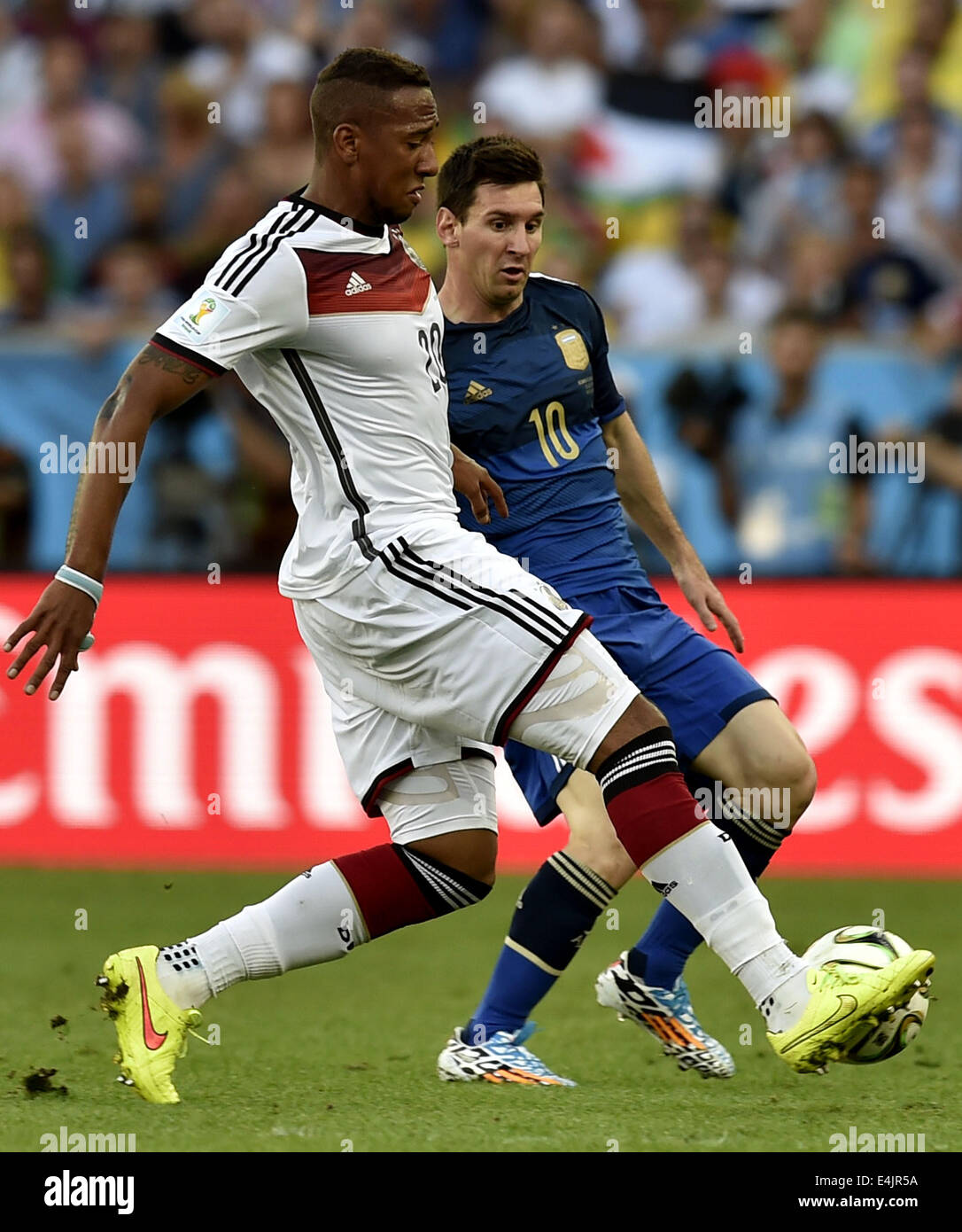 Rio De Janeiro, Brazil. 13th July, 2014. Germany's Jerome Boateng (L) controls the ball against Argentina's Lionel Messi during the final match between Germany and Argentina of 2014 FIFA World Cup at the Estadio do Maracana Stadium in Rio de Janeiro, Brazil, on July 13, 2014. Credit:  Qi Heng/Xinhua/Alamy Live News Stock Photo