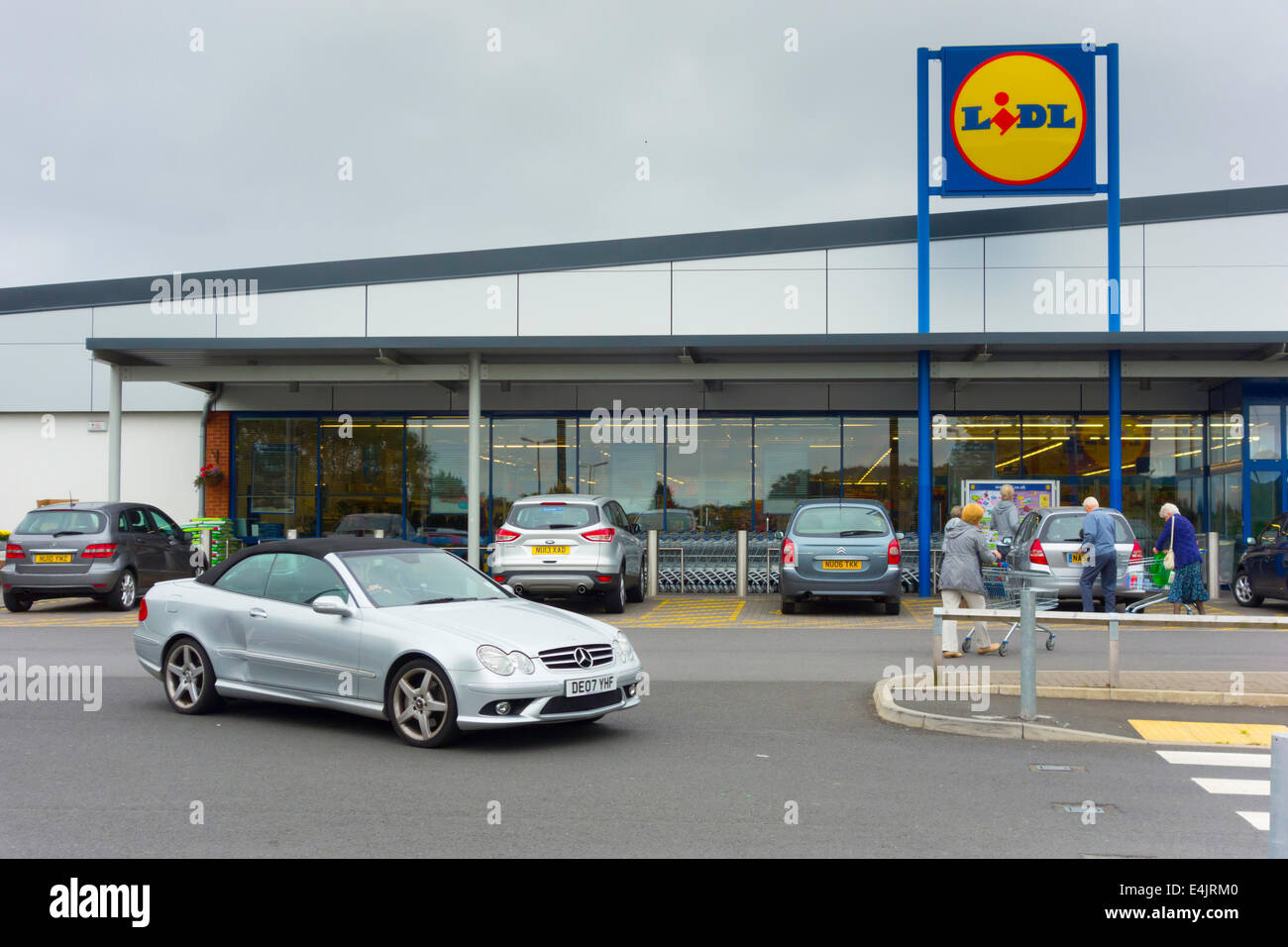Lidl low cost supermarket attracting better off middle class customers, here one driving away in a Mercedes Benz Coupe Stock Photo