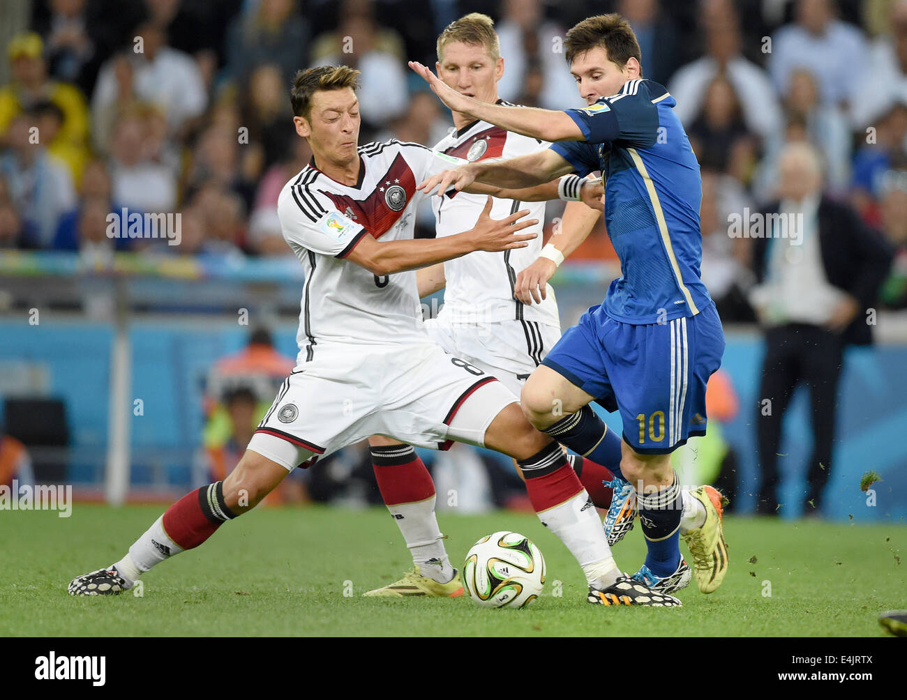 Rio de Janeiro, Brazil. 13th July, 2014. Mesut Oezil (L), Bastian Schweinsteiger (C) of Germany and Lionel Messi (R) of Argentina vie for the ball during the FIFA World Cup 2014 final soccer match between Germany and Argentina at the Estadio do Maracana in Rio de Janeiro, Brazil, 13 July 2014. Photo: Marcus Brandt/dpa/Alamy Live News Stock Photo