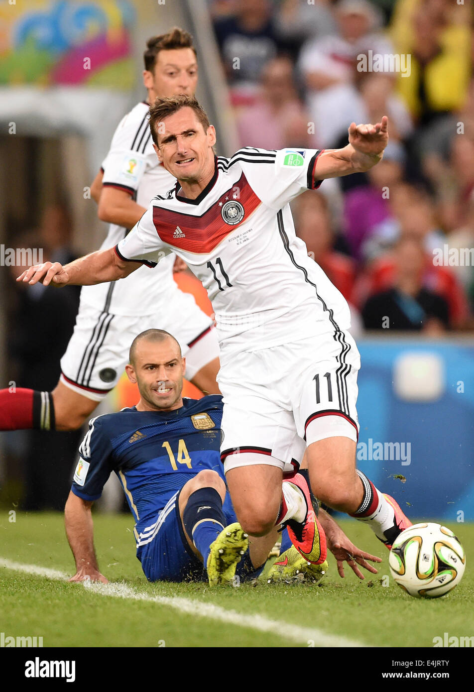 Rio de Janeiro, Brazil. 13th July, 2014. Miroslav Klose of Germany is fouled by Javier Mascherano of Argentina vie for the ball during the FIFA World Cup 2014 final soccer match between Germany and Argentina at the Estadio do Maracana in Rio de Janeiro, Brazil, 13 July 2014. Photo: Marcus Brandt/dpa/Alamy Live News Stock Photo