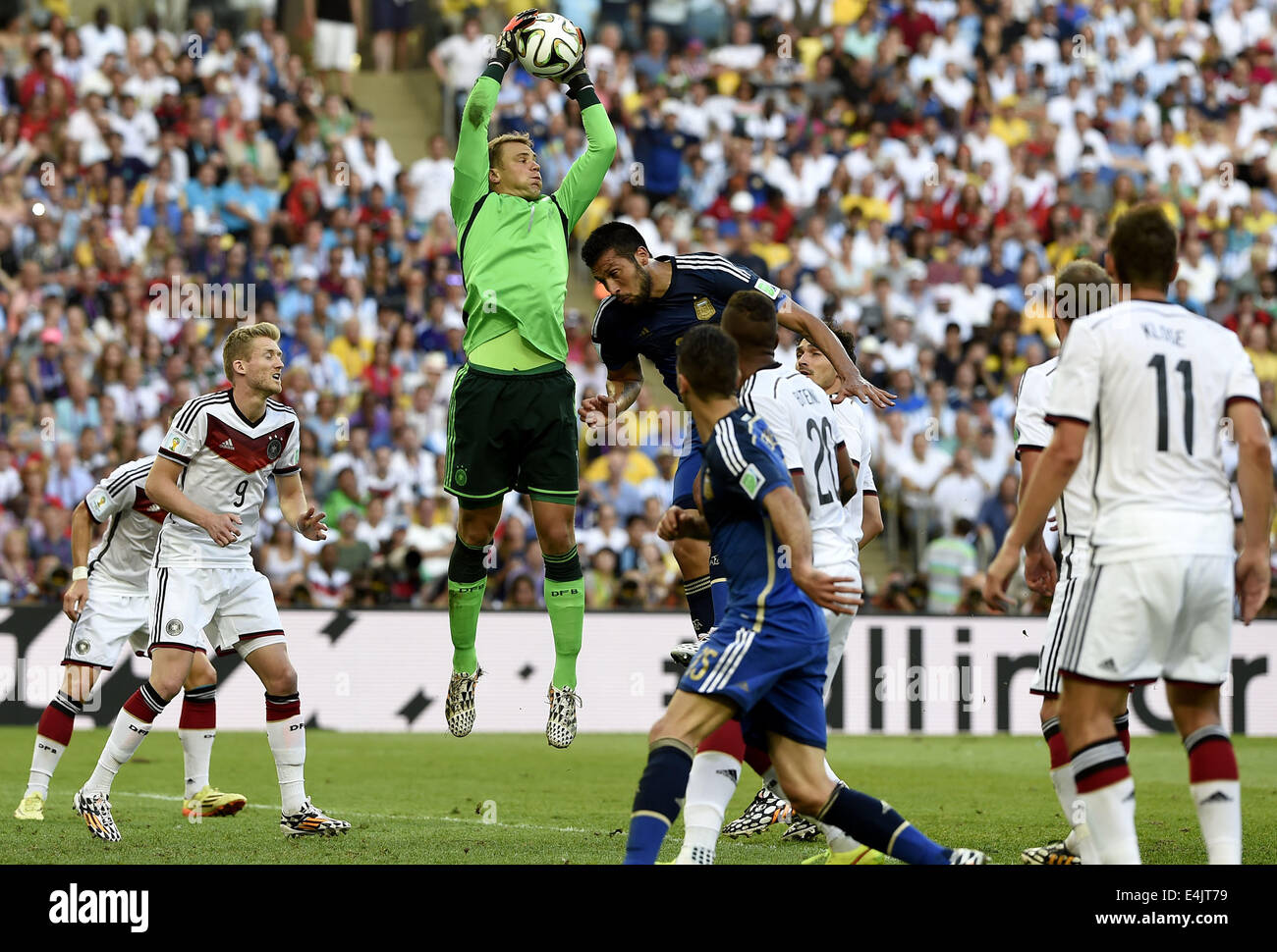 Rio De Janeiro, Brazil. 13th July, 2014. Germany's goalkeeper Manuel Neuer (3rd L) grabs the ball during the final match between Germany and Argentina of 2014 FIFA World Cup at the Estadio do Maracana Stadium in Rio de Janeiro, Brazil, on July 13, 2014. Credit:  Qi Heng/Xinhua/Alamy Live News Stock Photo