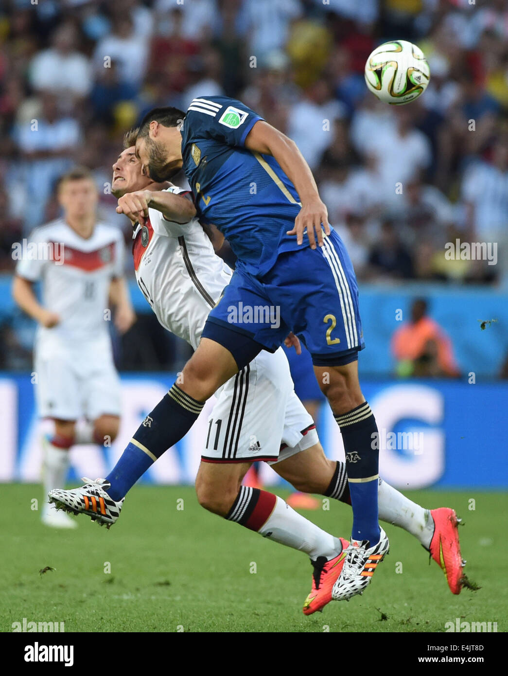 Rio De Janeiro, Brazil. 13th July, 2014. Argentina's Ezequiel Garay (R) vies with Germany's Miroslav Klose during the final match between Germany and Argentina of 2014 FIFA World Cup at the Estadio do Maracana Stadium in Rio de Janeiro, Brazil, on July 13, 2014. Credit:  Liu Dawei/Xinhua/Alamy Live News Stock Photo