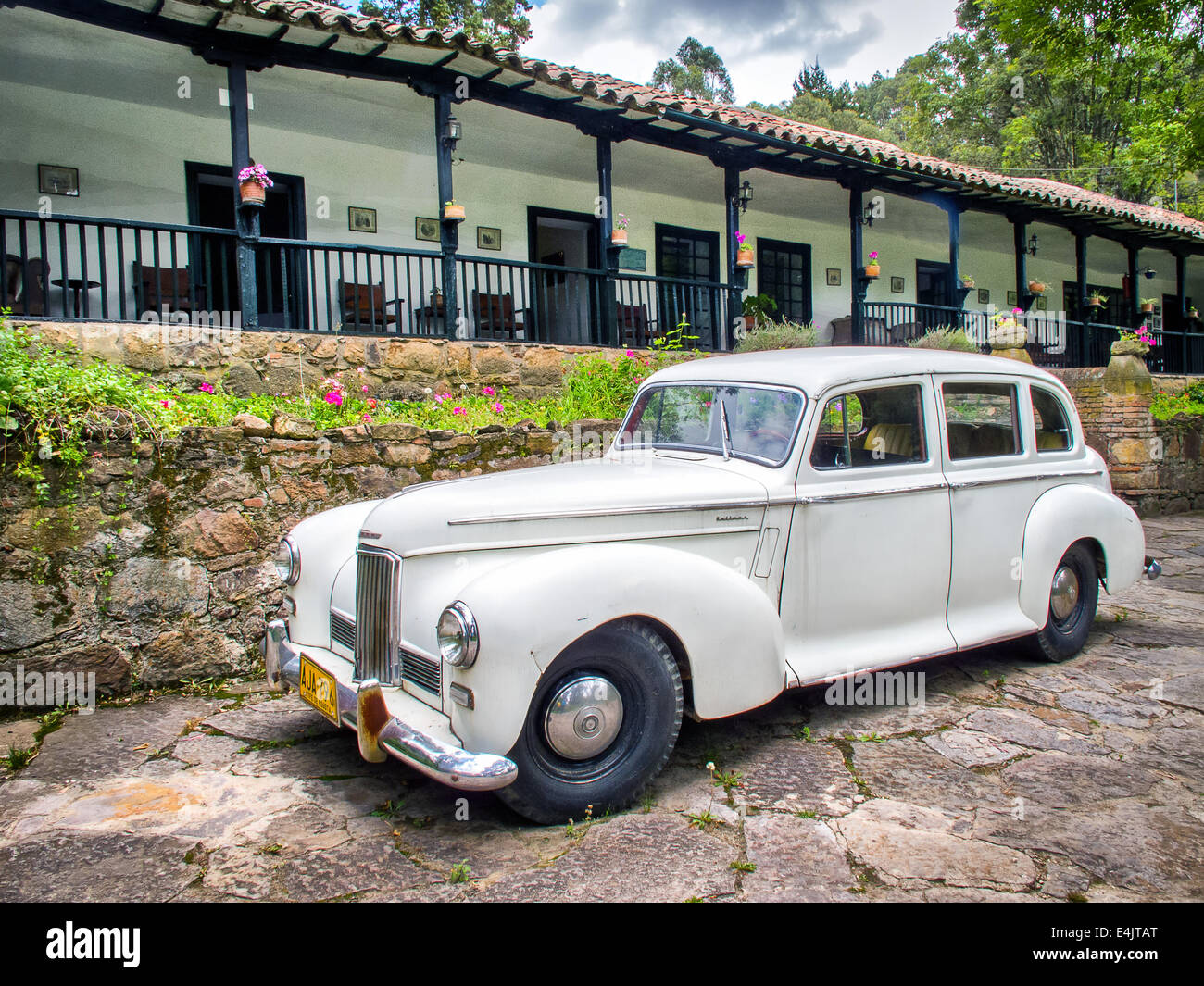 Old car in front of colonial house Stock Photo Alamy