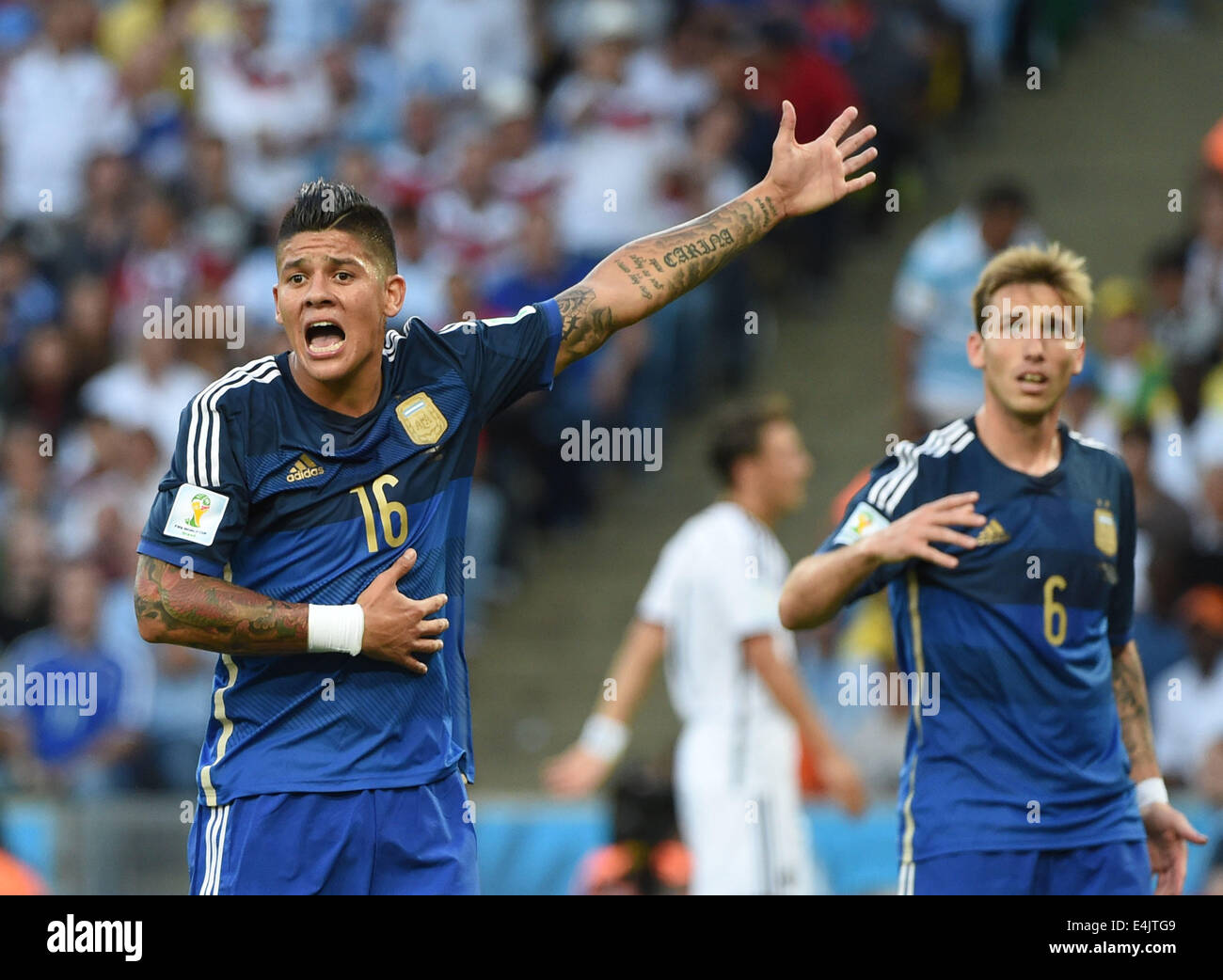 Rio De Janeiro, Brazil. 13th July, 2014. Argentina's Marcos Rojo (L) reacts during the final match between Germany and Argentina of 2014 FIFA World Cup at the Estadio do Maracana Stadium in Rio de Janeiro, Brazil, on July 13, 2014. Credit:  Liu Dawei/Xinhua/Alamy Live News Stock Photo