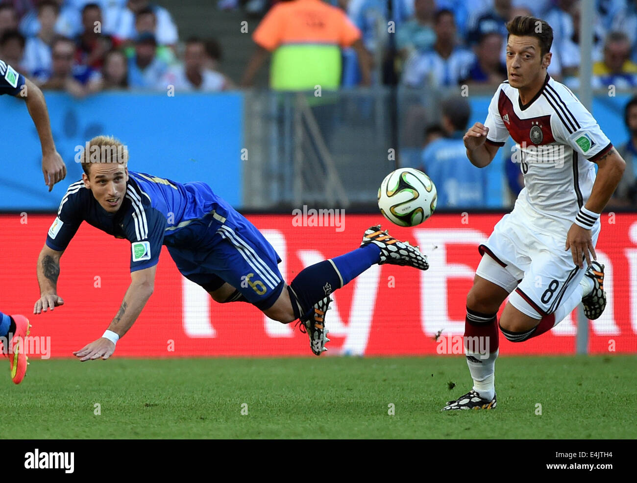 Rio De Janeiro, Brazil. 13th July, 2014. Argentina's Lucas Biglia (L) vies with Germany's Mesut Ozil during the final match between Germany and Argentina of 2014 FIFA World Cup at the Estadio do Maracana Stadium in Rio de Janeiro, Brazil, on July 13, 2014. Credit:  Liu Dawei/Xinhua/Alamy Live News Stock Photo