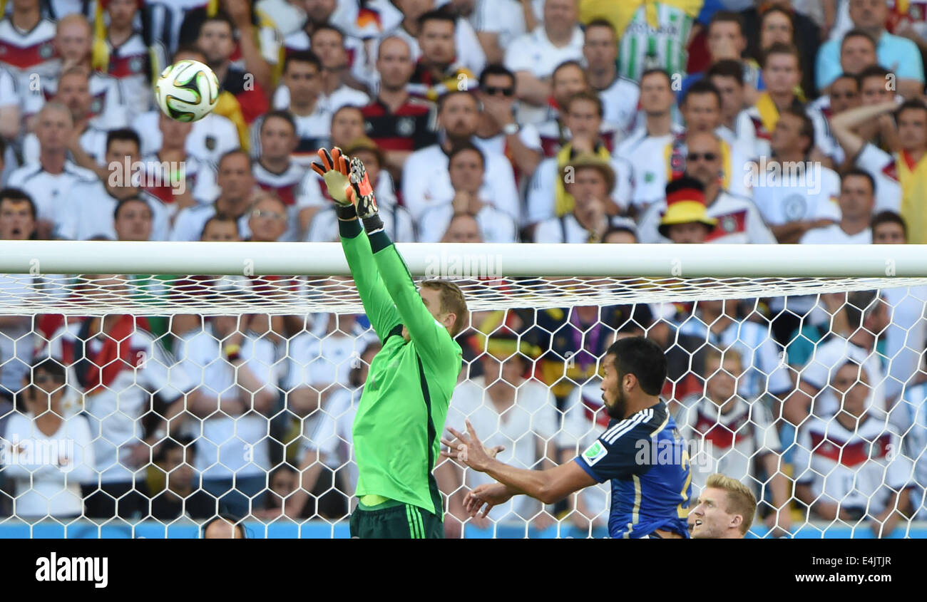 Rio De Janeiro, Brazil. 13th July, 2014. Germany's goalkeeper Manuel Neuer (L) blocks the ball during the final match between Germany and Argentina of 2014 FIFA World Cup at the Estadio do Maracana Stadium in Rio de Janeiro, Brazil, on July 13, 2014. Credit:  Guo Yong/Xinhua/Alamy Live News Stock Photo