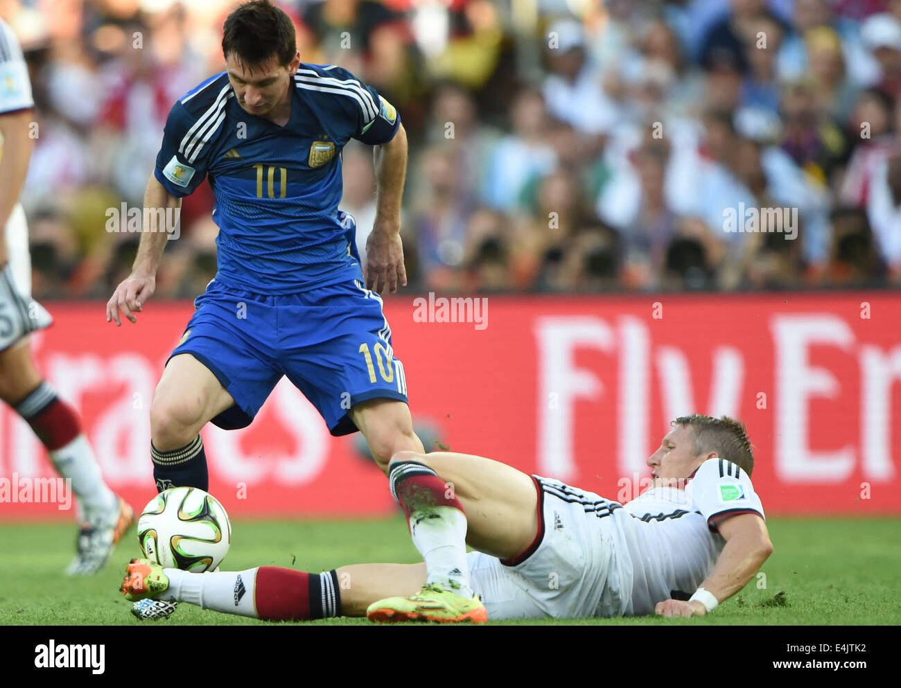 Rio De Janeiro, Brazil. 13th July, 2014. Argentina's Lionel Messi (L) vies with Germany's Bastian Schweinsteiger during the final match between Germany and Argentina of 2014 FIFA World Cup at the Estadio do Maracana Stadium in Rio de Janeiro, Brazil, on July 13, 2014. Credit:  Guo Yong/Xinhua/Alamy Live News Stock Photo
